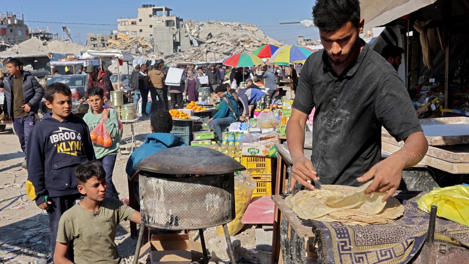 A Palestinian street vendor sells bread at a market in Jabalia in the northern Gaza Strip, on 27 February 2025 (Omar al-Qattaa/AFP)