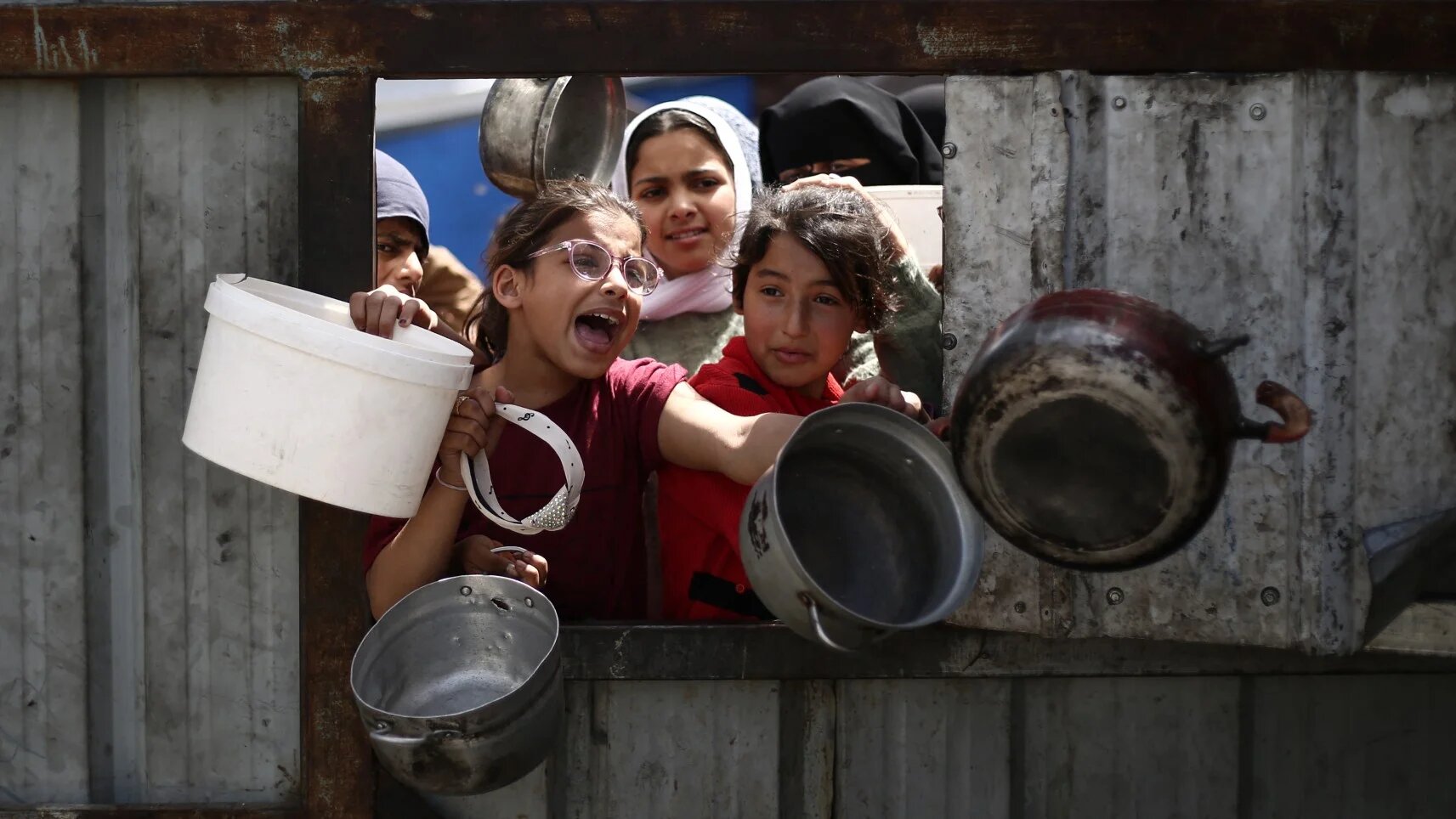 Palestinian children line up to collect free food in the Nuseirat refugee camp in the central Gaza Strip on 3 April 2025 (Eyad Baba/AFP)