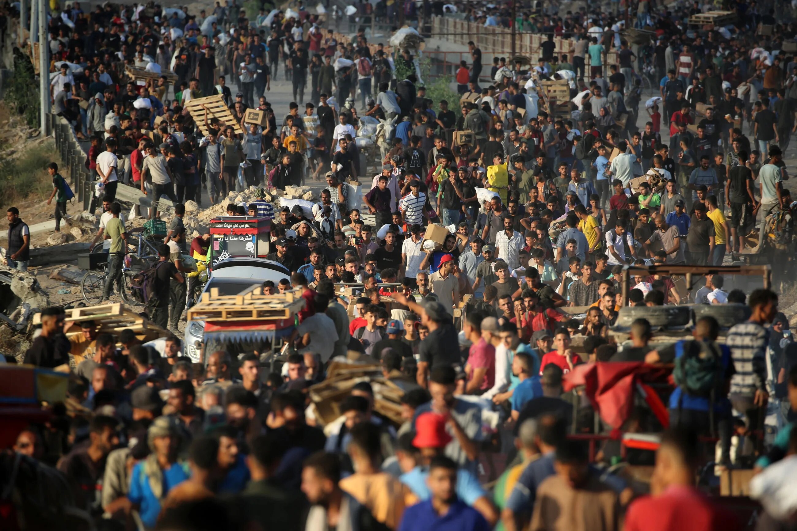 Palestinians gather at an aid distribution point set up by the Gaza Humanitarian Foundation (GHF), near the Nuseirat refugee camp on 25 June 2025 (Eyad Baba/AFP)