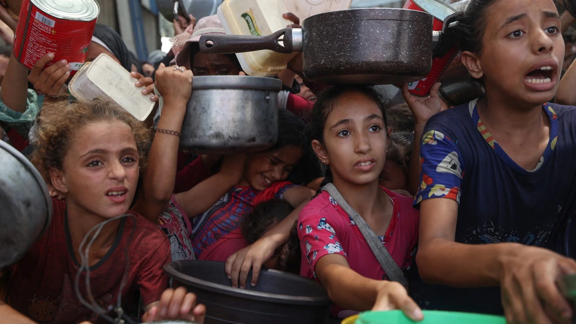 Palestinians gather to receive cooked meals from a food distribution centre in the Nuseirat refugee camp in the central Gaza Strip on 18 August 2025 (Eyad Baba/AFP)