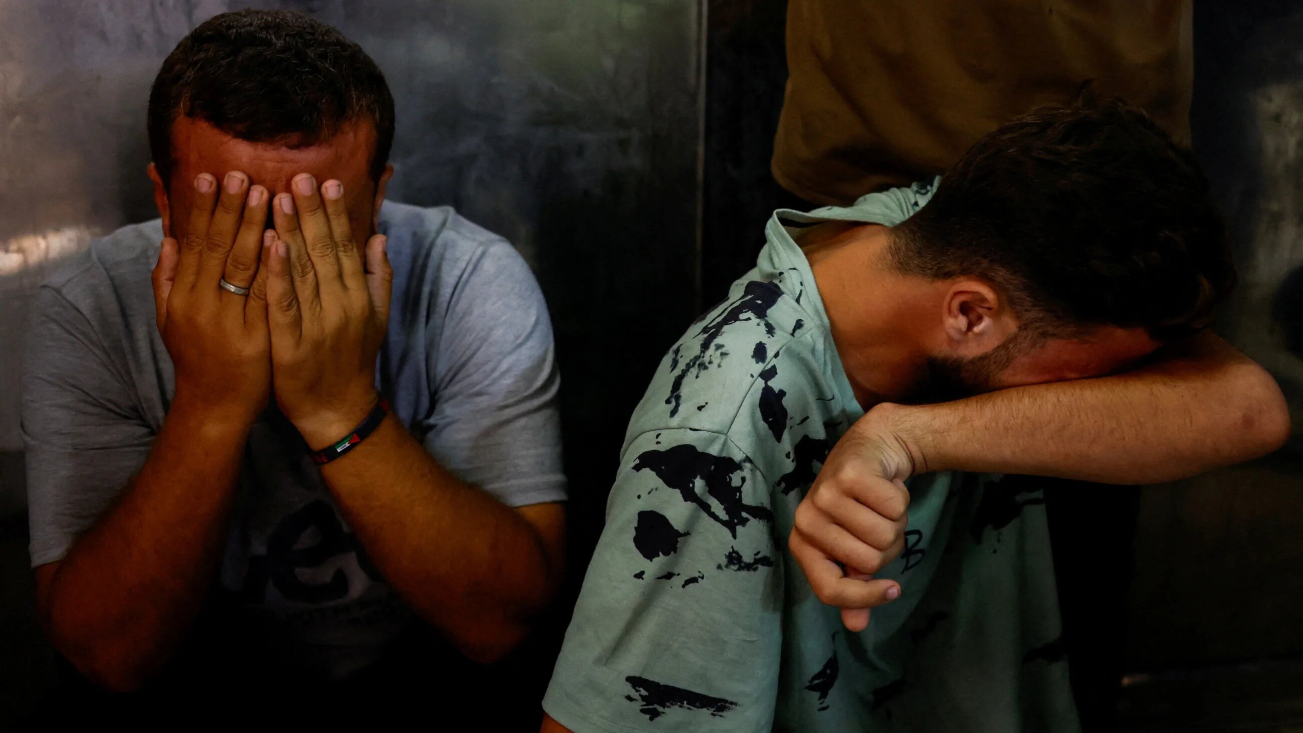 Mourners react at the morgue of Al-Shifa hospital where bodies of Palestinians killed in Israeli fire are kept, in Gaza City, 28 August 2025 (Reuters)