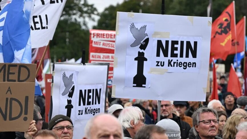 Holding signs that say “no to wars”, protesters take part in an anti-war demonstration in Berlin, Germany, on 3 October 2024 (Ralf Hirschberger/AFP)