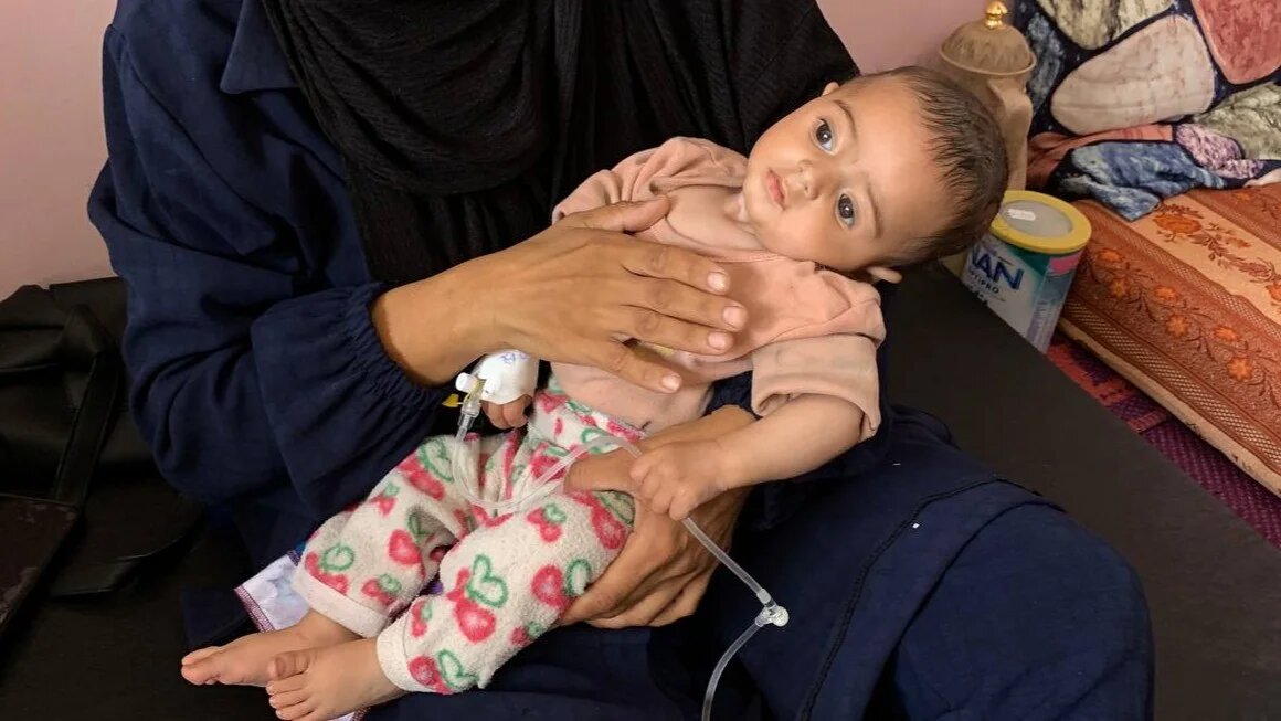 Grandmother to Awnee al-Jorani, a Palestinian baby suffering from meningitis, says that her spends his day staring into nothingness and cries all night from the pain (MEE/Ahmed Aziz)