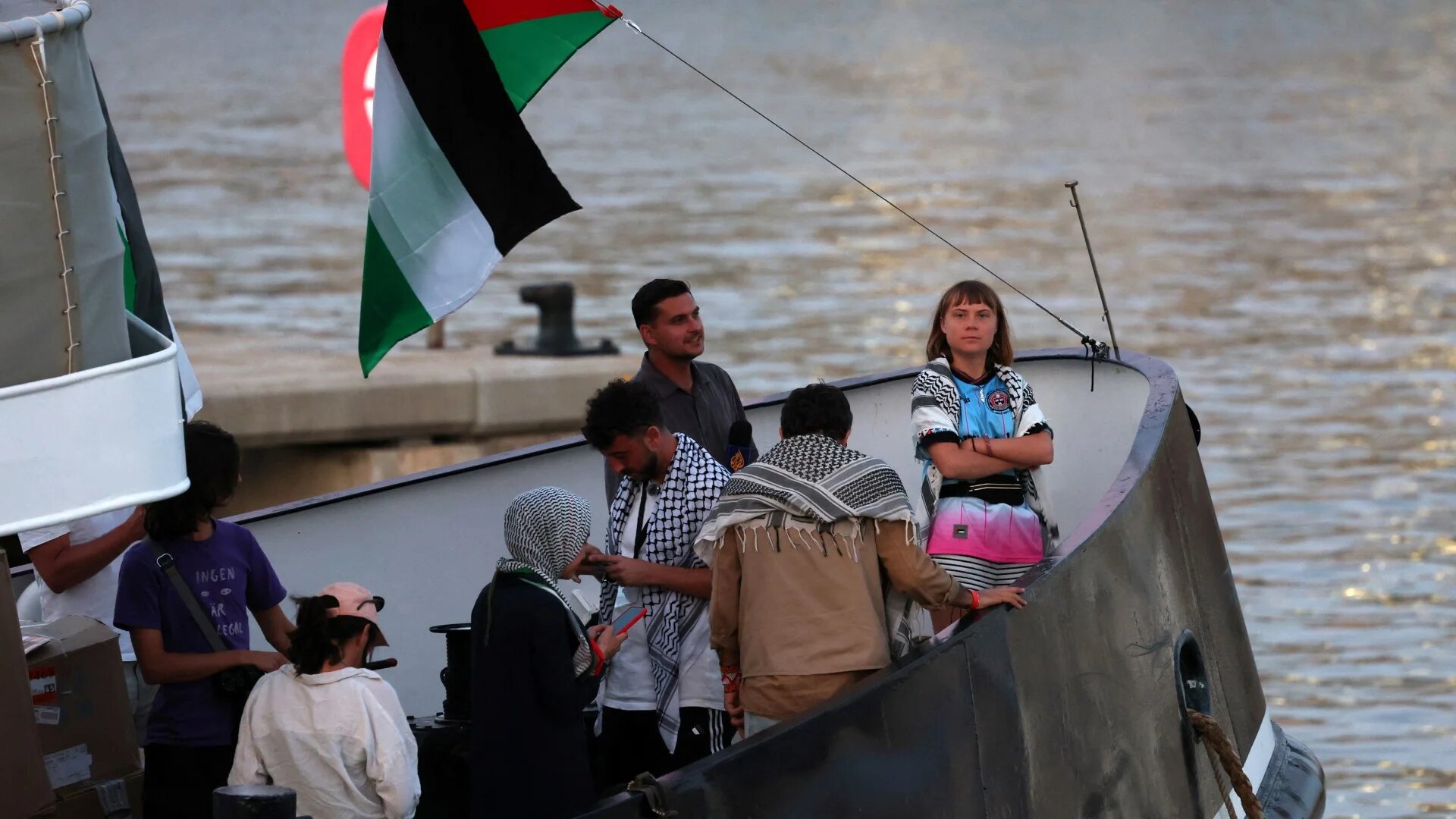 Swedish climate activist Greta Thunberg (right] is seen on board of a vessel of a civilian flotilla aiming to break the Israeli blockade of the Gaza Strip, at Barcelona port on 1 September 2025 (AFP/Lluis Gene)