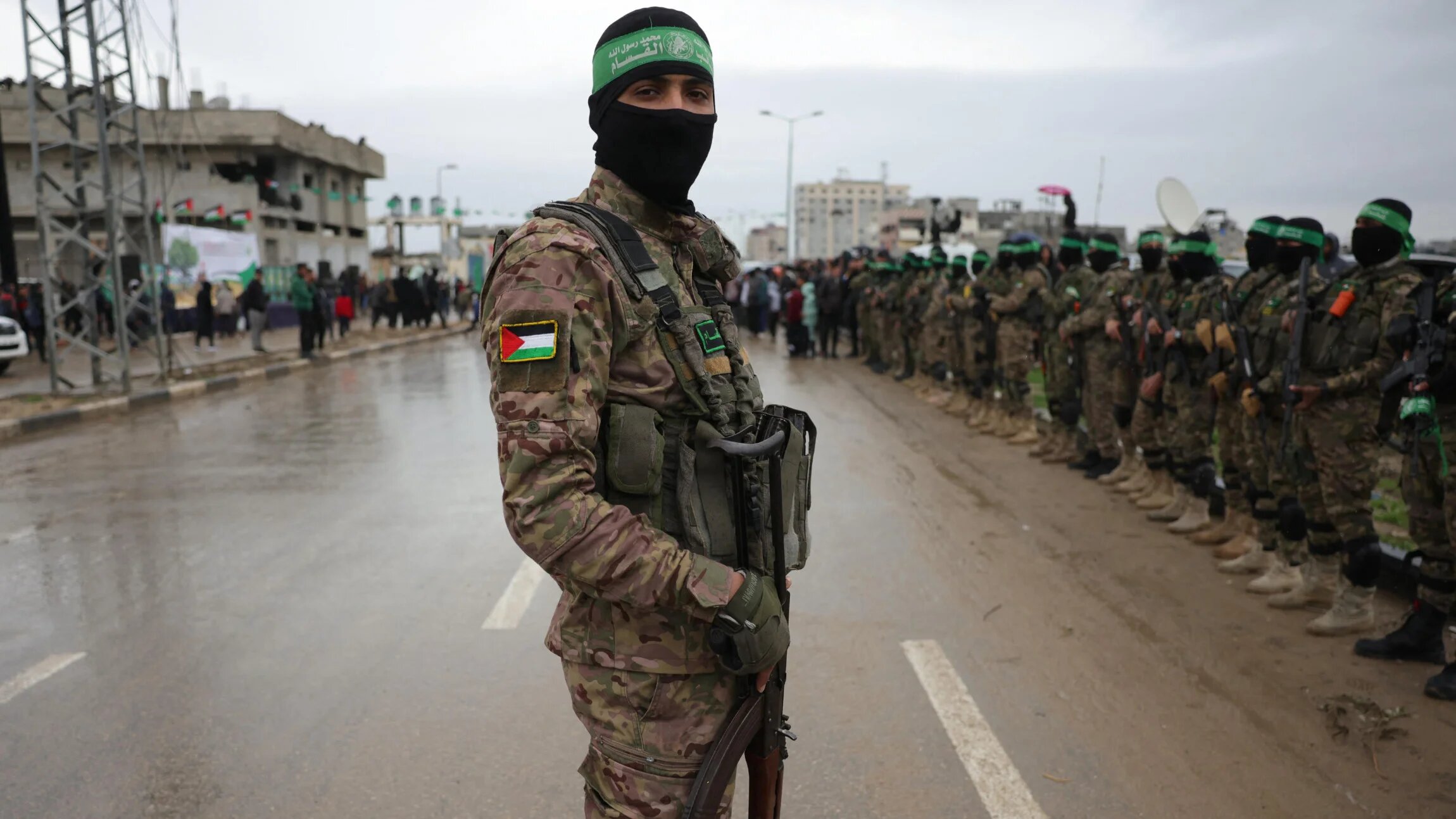 Palestinian Hamas fighters gather at the site of the handing over of Israeli captives at the Nuseirat refugee camp in the central Gaza Strip, 22 February 2025 (AFP)