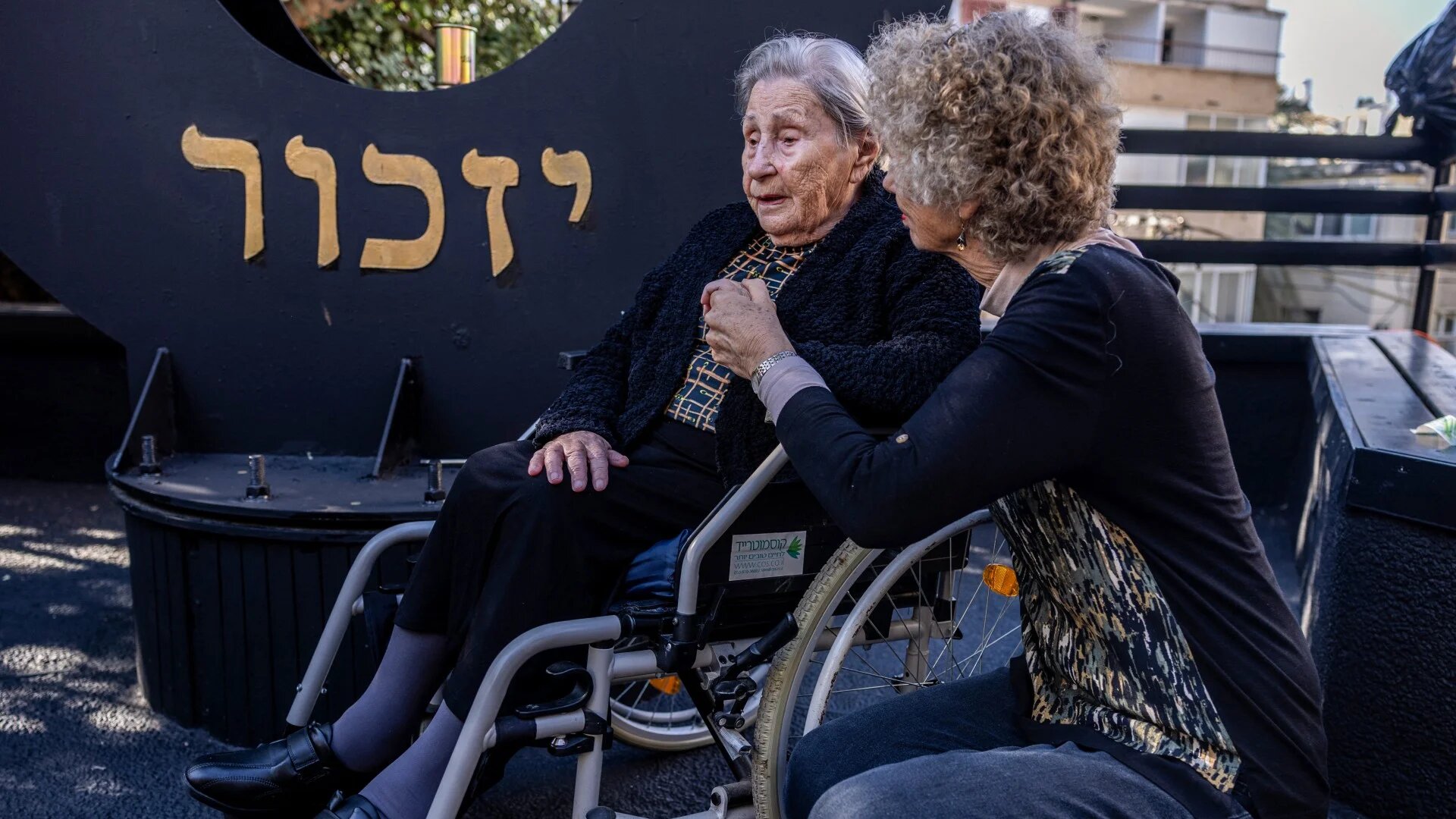 Miriam Linial (L), a 103 years old Holocaust and Auschwitz concentration camp survivor, attends the the International Holocaust Memorial Day, in Haifa, on 27 January 2025 (AFP/Menahem Kahana)