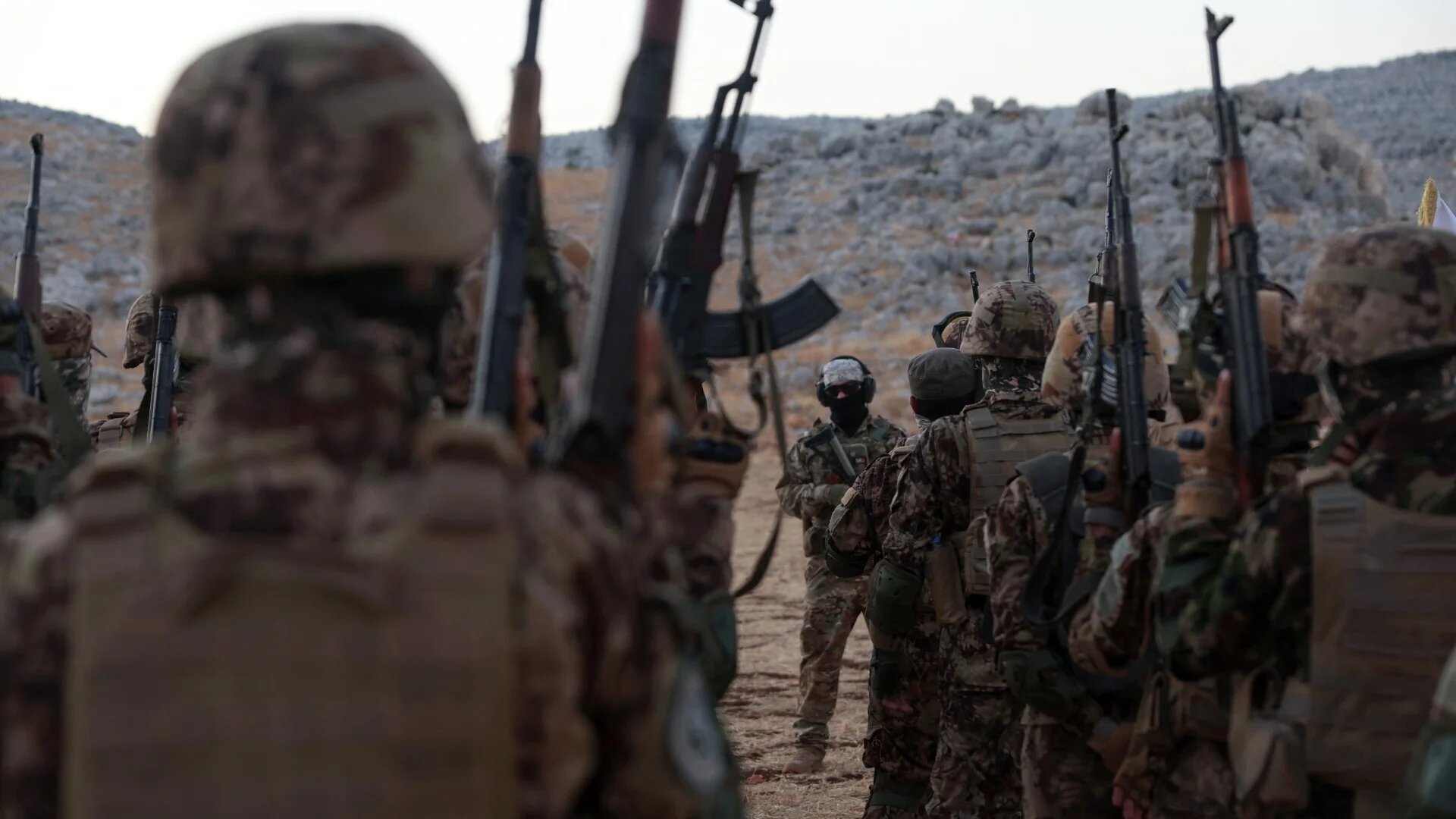 Fighters from the jihadist group Hay'at Tahrir al-Sham in Idlib province on 16 August, 2023 (AFP/Omar Haj Kadour)