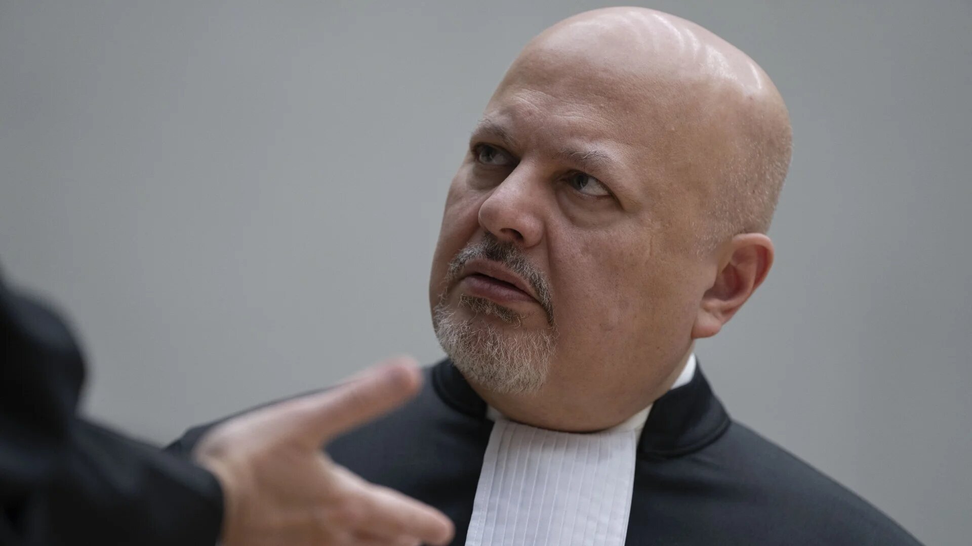 International Criminal Court Prosecutor Karim Khan is photographed talking to another lawyer in The Hague on 14 March 2025 (Peter Dejong/AFP)