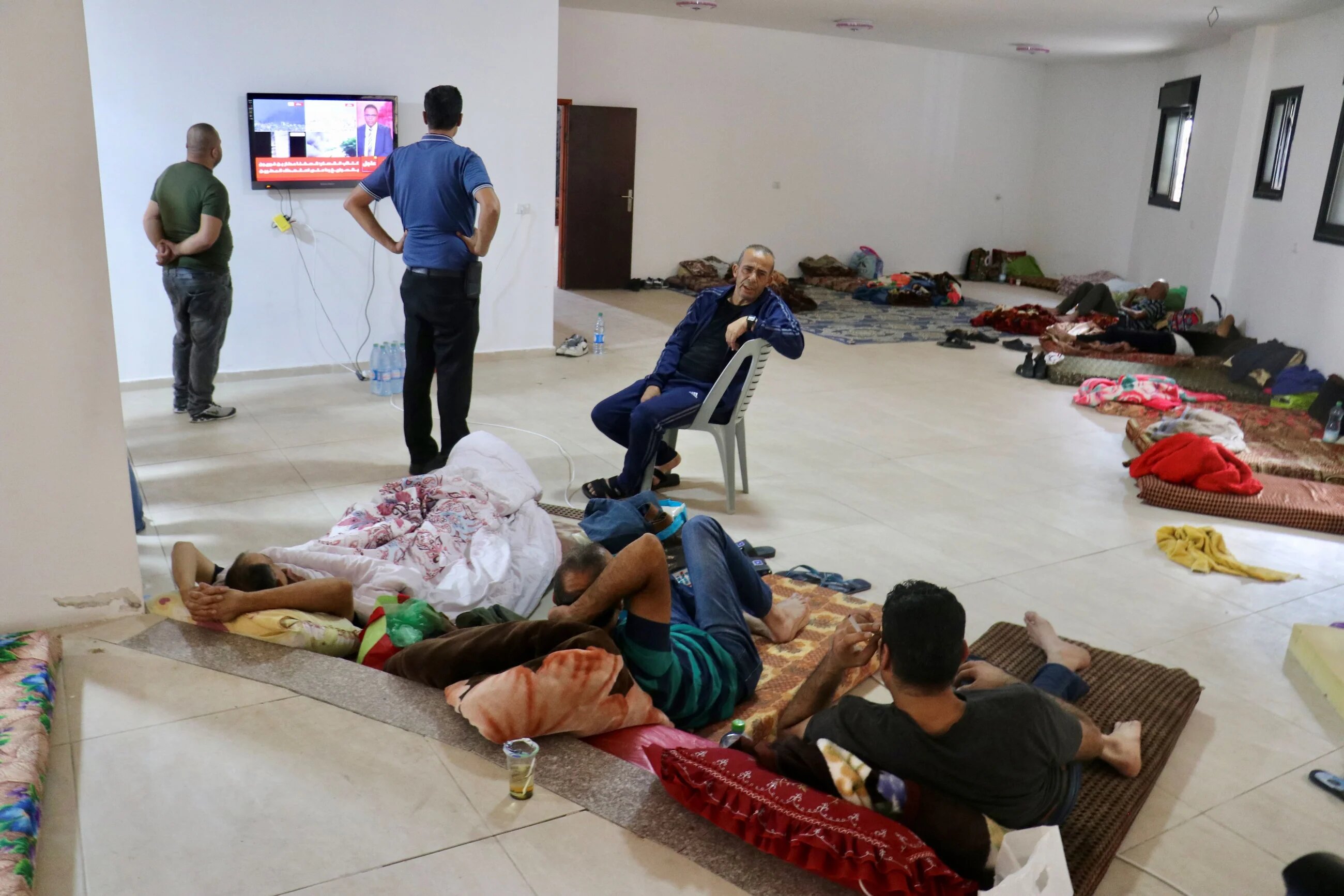 Palestinian workers stranded in Tarkumya in the West Bank after having their work permits revoked (MEE/Misab Shawir)