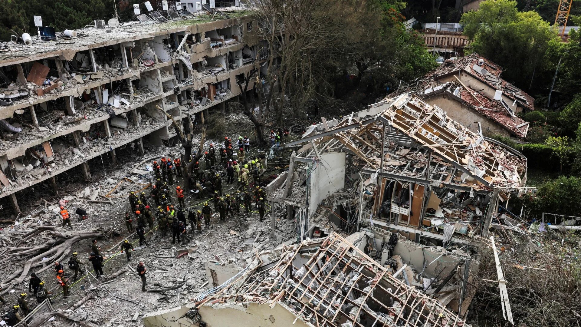 Rescuers and security personnel work at the impacted site after a missile attack from Iran in Tel Aviv, 22 June (Reuters/Tomer Appelbaum)