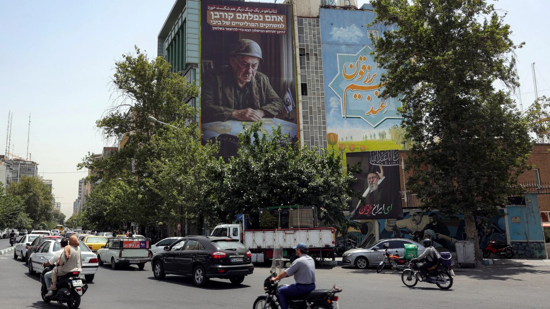 Motorists drive their vehicles along the roundabout at Palestine Square in central Tehran on 8 July 2025 (AFP)
