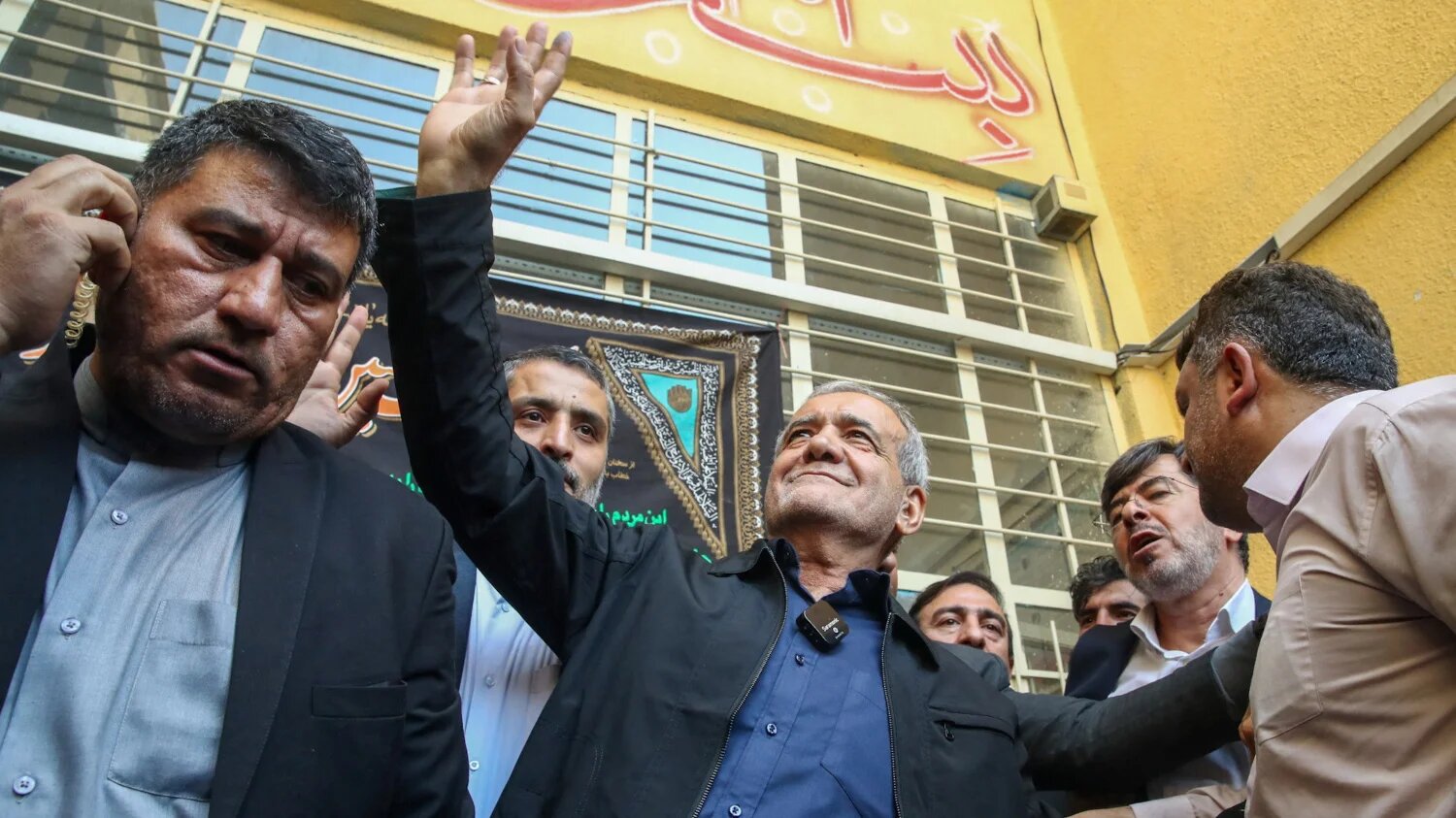 Iranaian presidential candidate Masoud Pezeshkian waves at the crowd during the run-off presidential elections (Saeed Zareian/pool/WANA (West Asia News Agency)/Reuters)