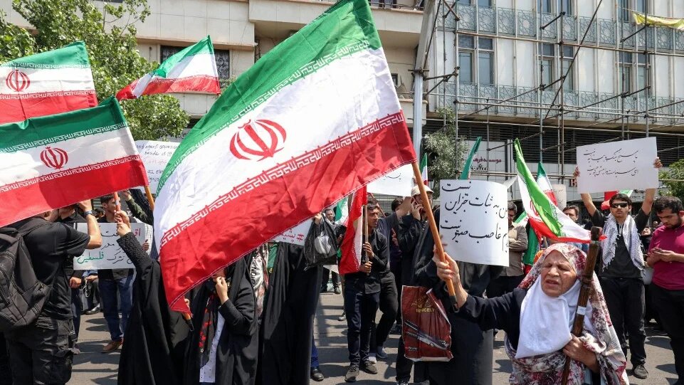 People gather in central Tehran to protest against Israel’s wave of strikes on Iran on 13 June 2025 (Atta Kenare/AFP)