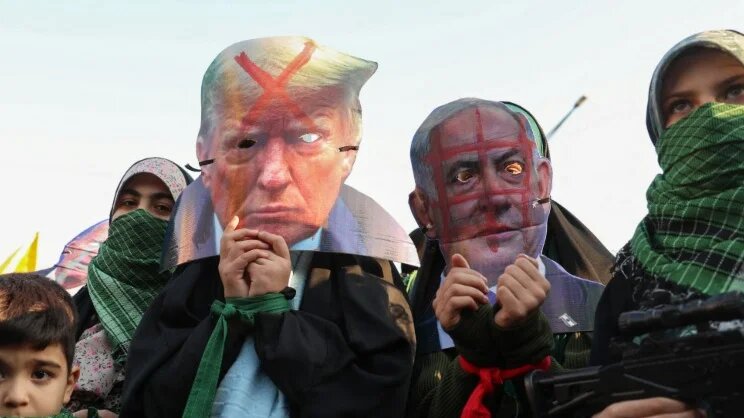 Protesters in Tehran wear masks denouncing US President Donald Trump and Israeli Prime Minister Benjamin Netanyahu on 10 January 2025 (AFP)