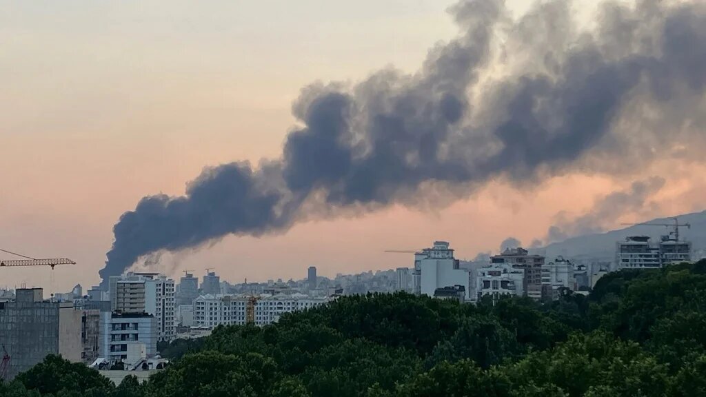 Smoke billows from the building housing Iran’s state broadcaster in Tehran after an Israeli strike on 16 June 2025 (AFP)