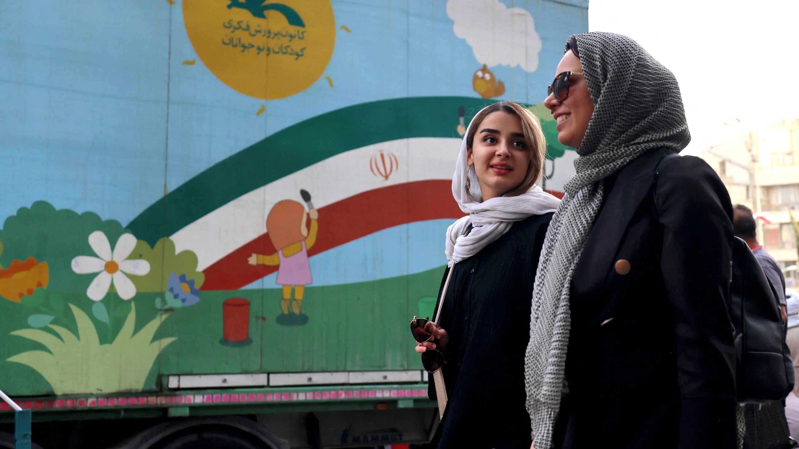 Iranian women walk at Enghelab Square in the capital Tehran on 24 June 2025 (AFP)