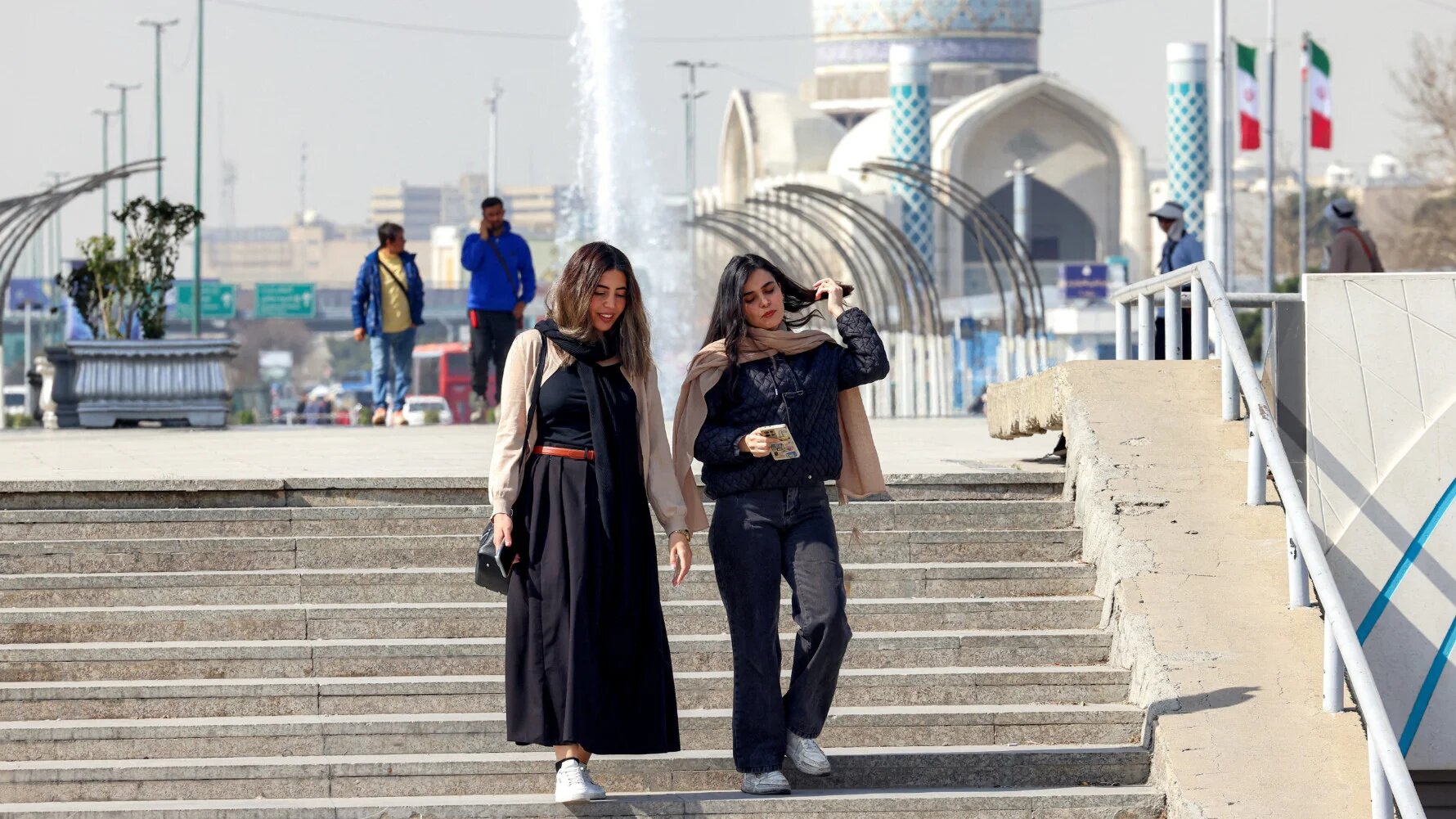 Iranians walk through Azadi Square in Tehran on 23 February 2026 (AFP)