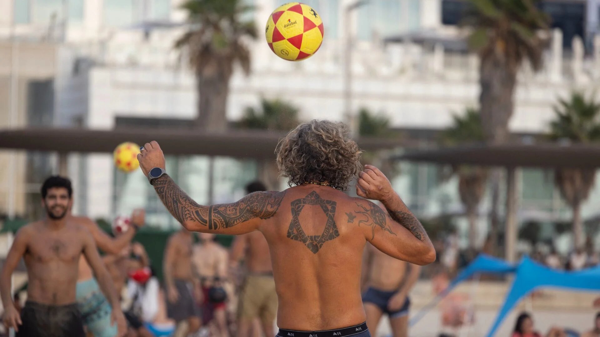 People play at the beach in Tel Aviv, on 7 August 2024, amid Israel's war on Gaza (Oren Ziv/AFP/file photo)