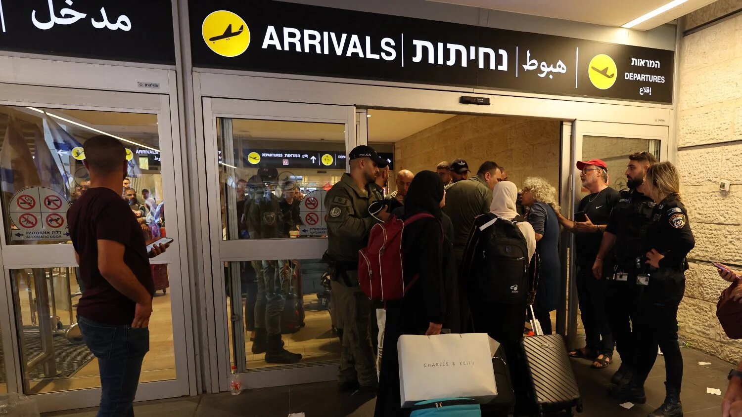 Travellers move with their luggage trolleys at Israel's Ben Gurion Airport on 3 July 2023.