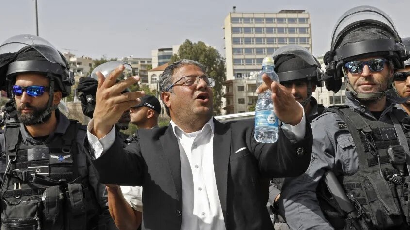 Israeli riot police surround far-right politician Itamar Ben Gvir in the Sheikh Jarrah neighbourhood of occupied East Jerusalem on 10 May 2021 (Gil Cohen-Magen/AFP)