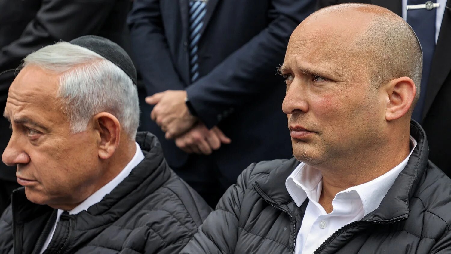 (L to R) Israel's prime minister-designate Benjamin Netanyahu and former prime minister Naftali Bennett attend a funeral on 26 December 2022.