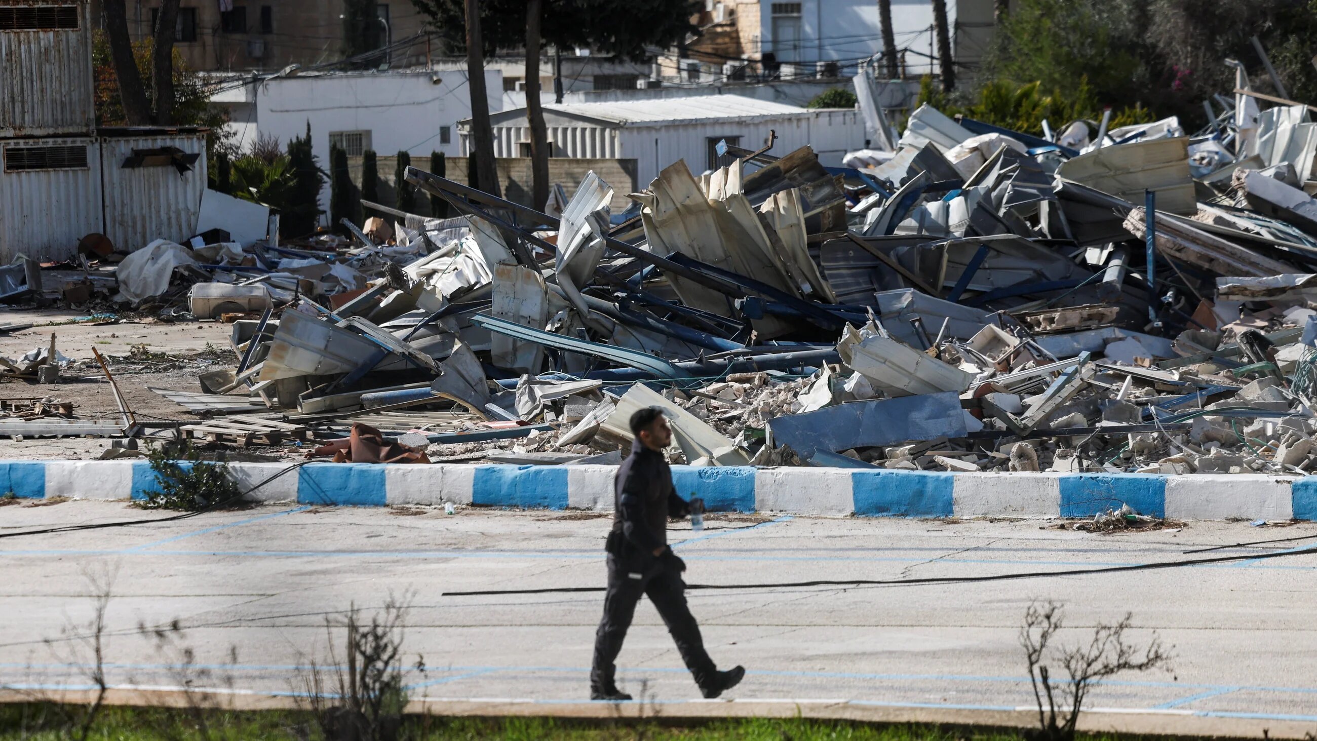 A member of the Israeli forces walks past the rubble of the demolished UN agency for Palestinian refugees (Unrwa) headquarters in East Jerusalem, 20 January, 2026 (Reuters/Ammar Awad)