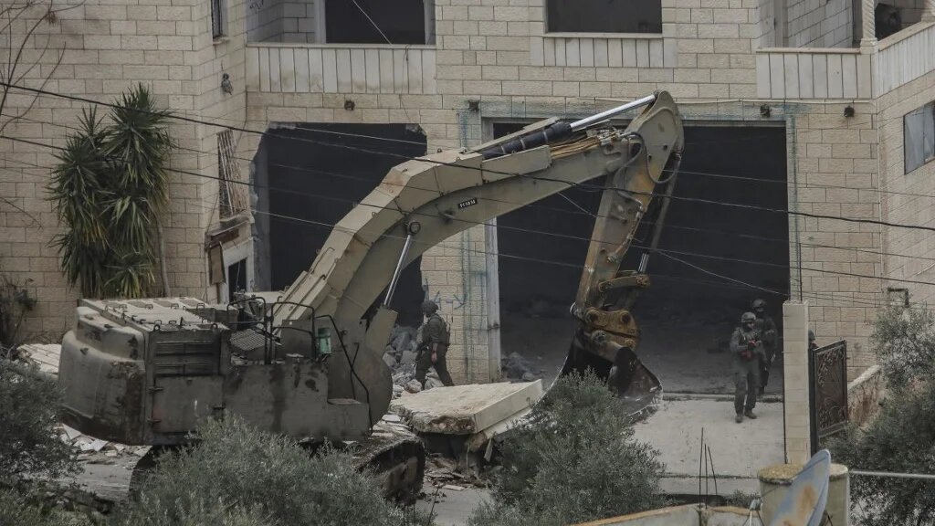 Israeli soldiers demolish a house in the village of Silat al-Harithiya, in the occupied West Bank, on 17 February 2026 (Mohammed Mansour/AFP)