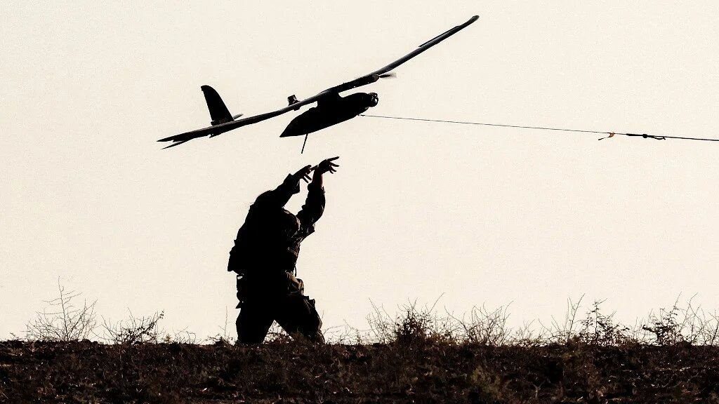 An Israeli soldier launches a surveillance drone near Gaza on 30 September 2025 (Jack Guez/AFP)