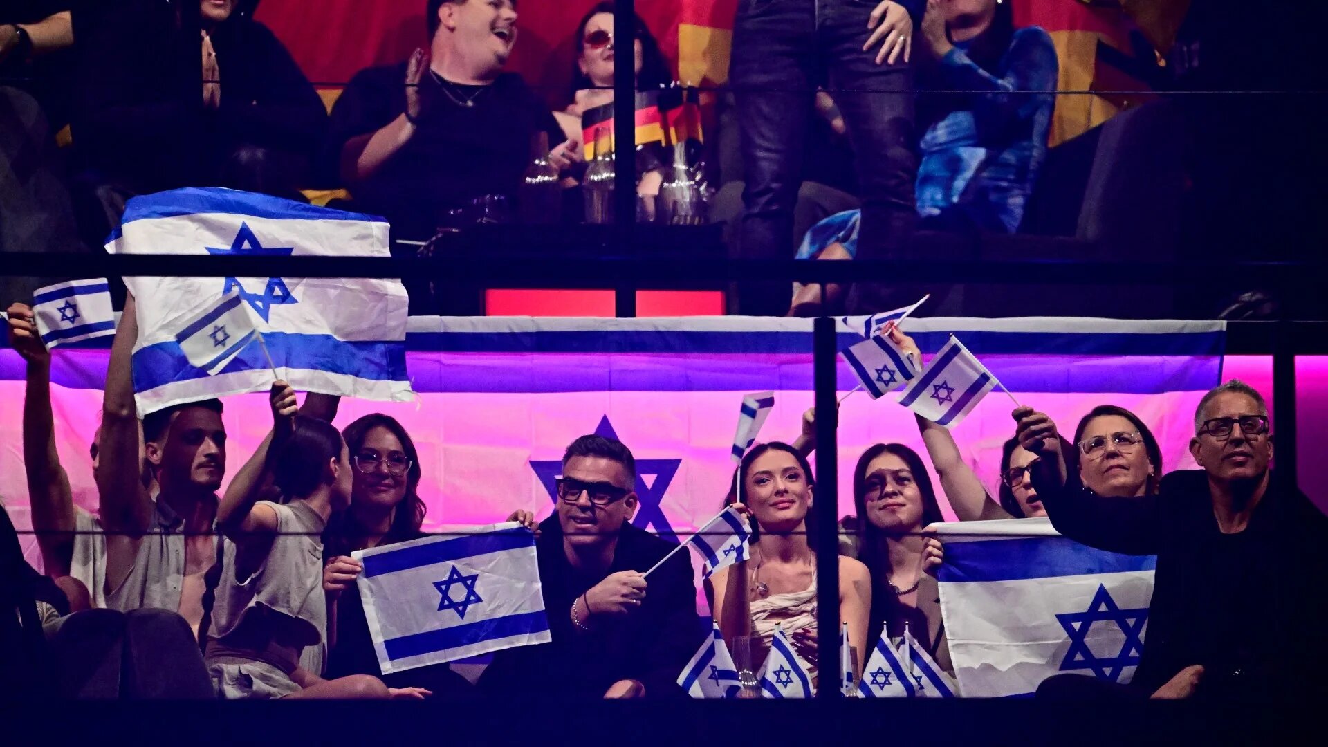 Israeli singer Eden Golan (C) representing Israel with the song "Hurricane" and team members react as votes are counted at the end of the final of the 68th Eurovision Song Contest 2024 on 11 May 2024 (AFP/Tobias Schwarz)