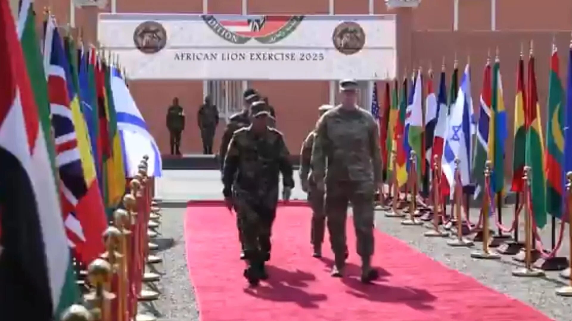 Troops from a number of nations walk past flags during the Africa Lion military drill in Morocco on 13 May 2025 (Screengrab/X)