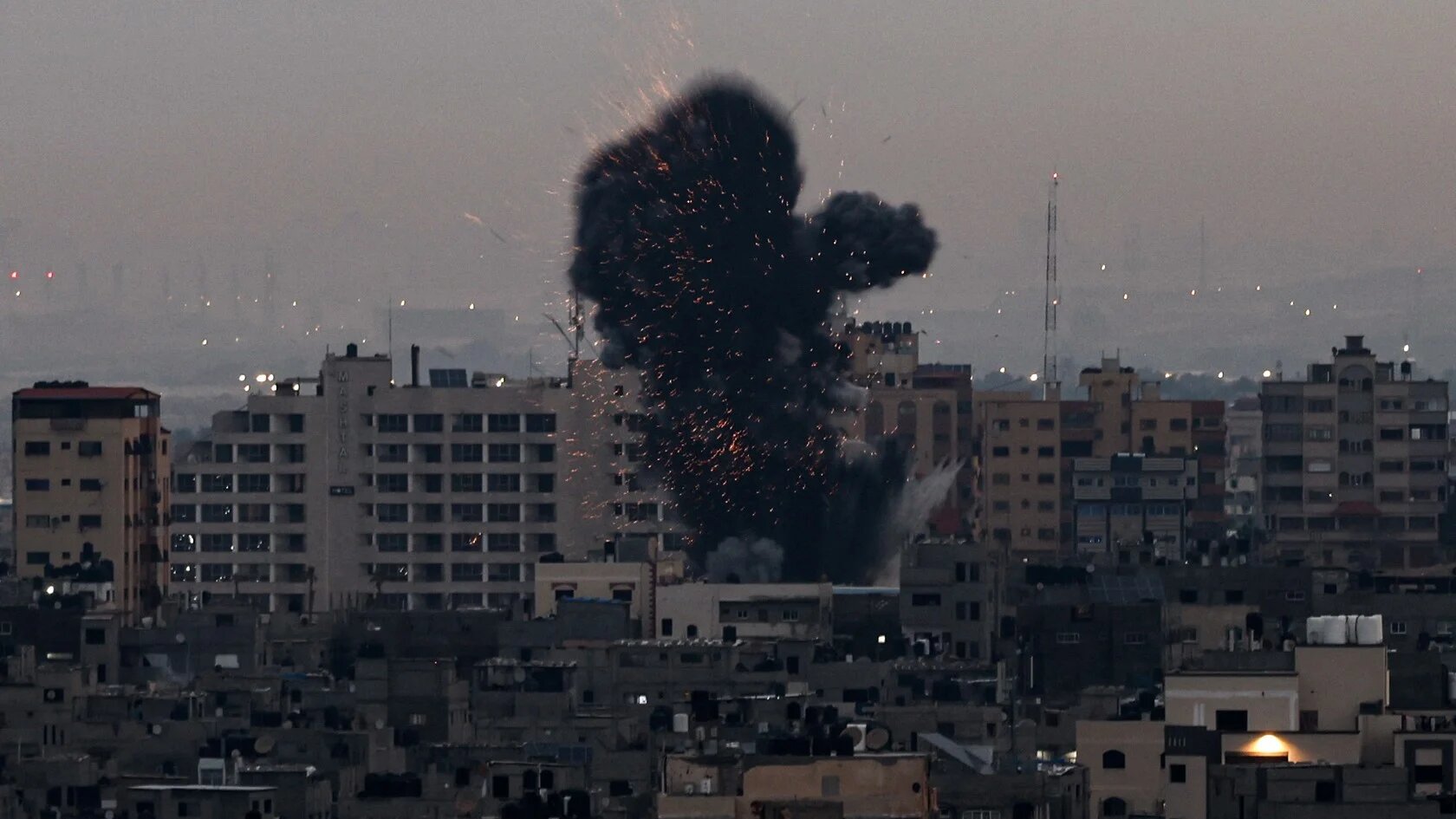 Smoke rises above buildings in Gaza City as Israel launched air strikes on the Palestinian enclave early on 23 February 2023 (AFP)