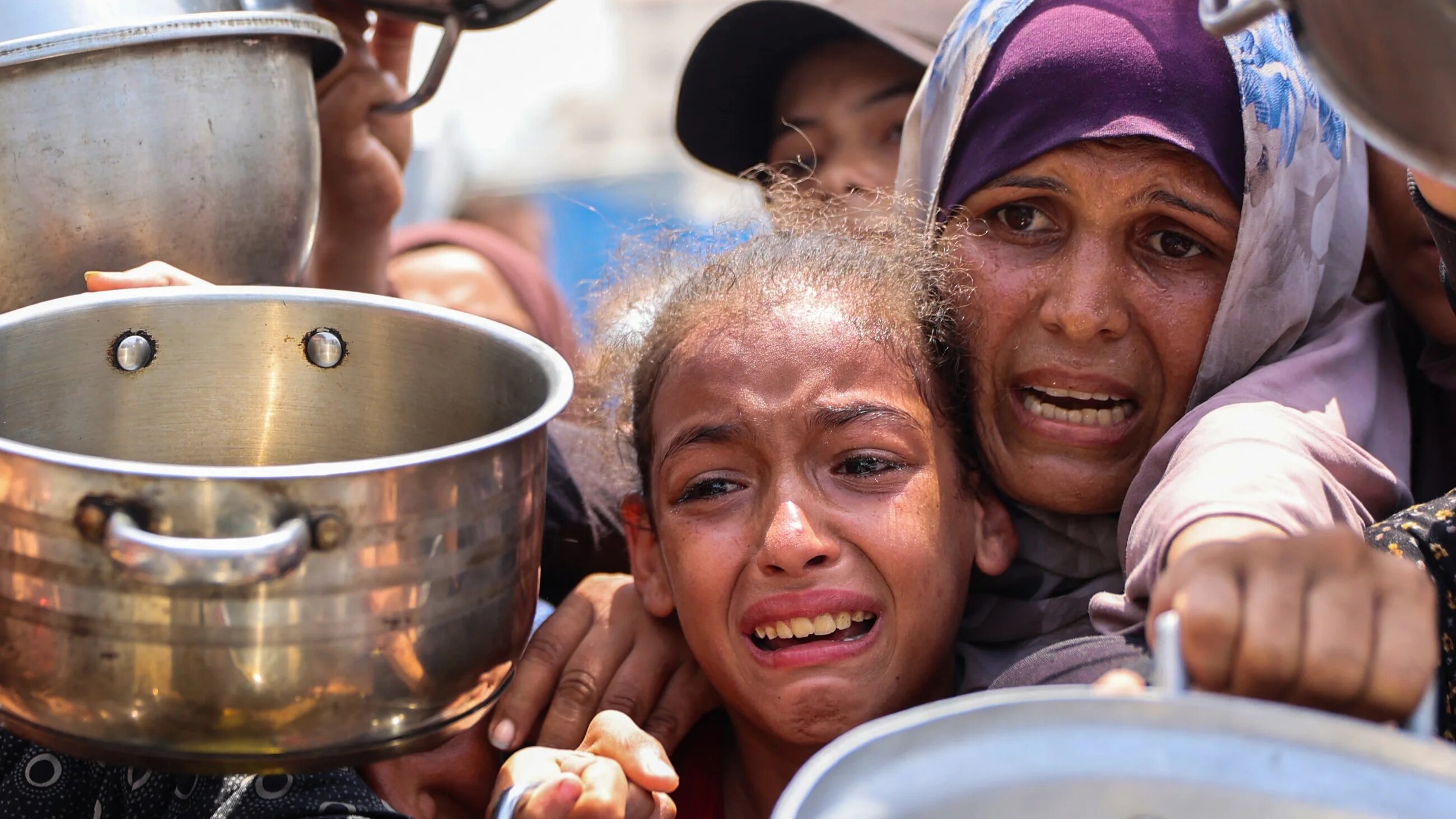 Palestinians gather to receive food in Gaza City as famine unfolds in the besieged territory, on 13 August 2025 (AFP/Omar al-Qattaa)
