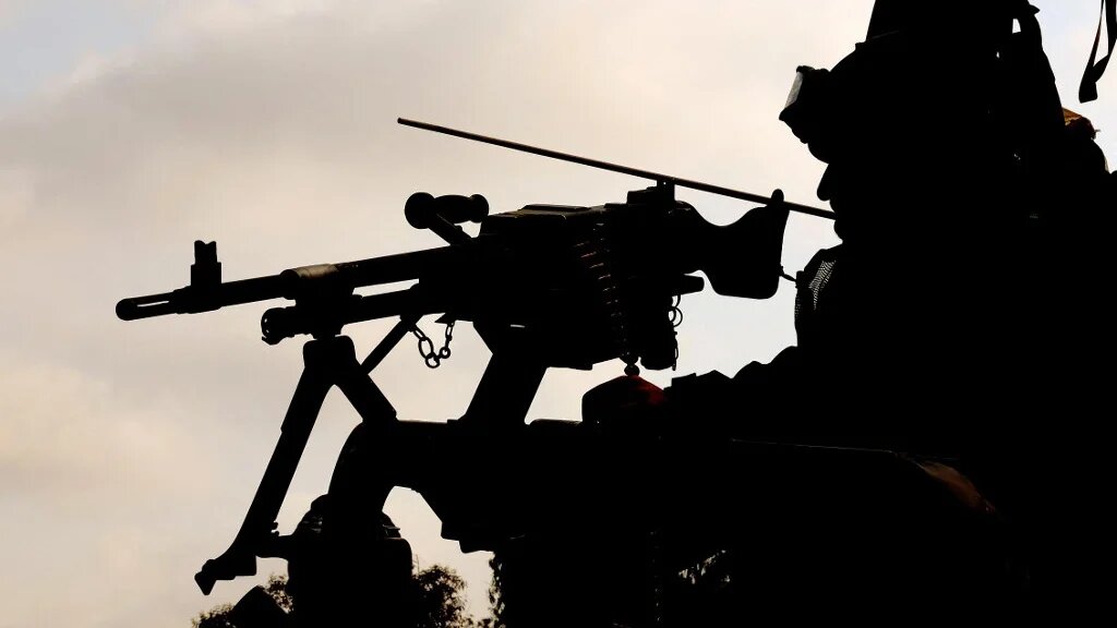 An Israeli soldier sits behind a mounted gun near Gaza on 1 May 2024 (Jack Guez/AFP)