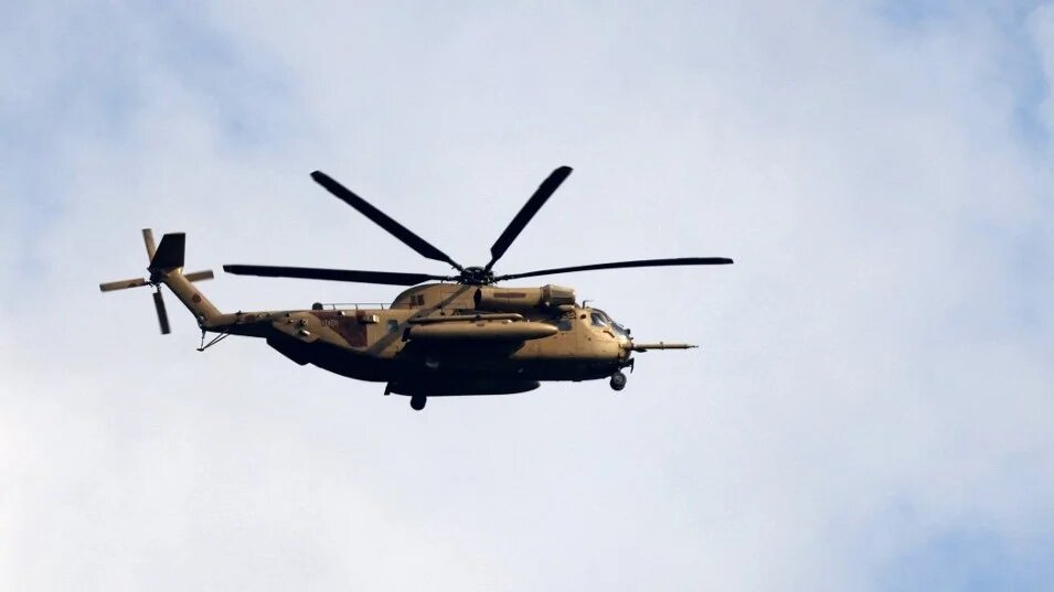 An Israeli Air Force helicopter hovers over the border area with south Lebanon in northern Israel on 22 February 2024 (AFP)