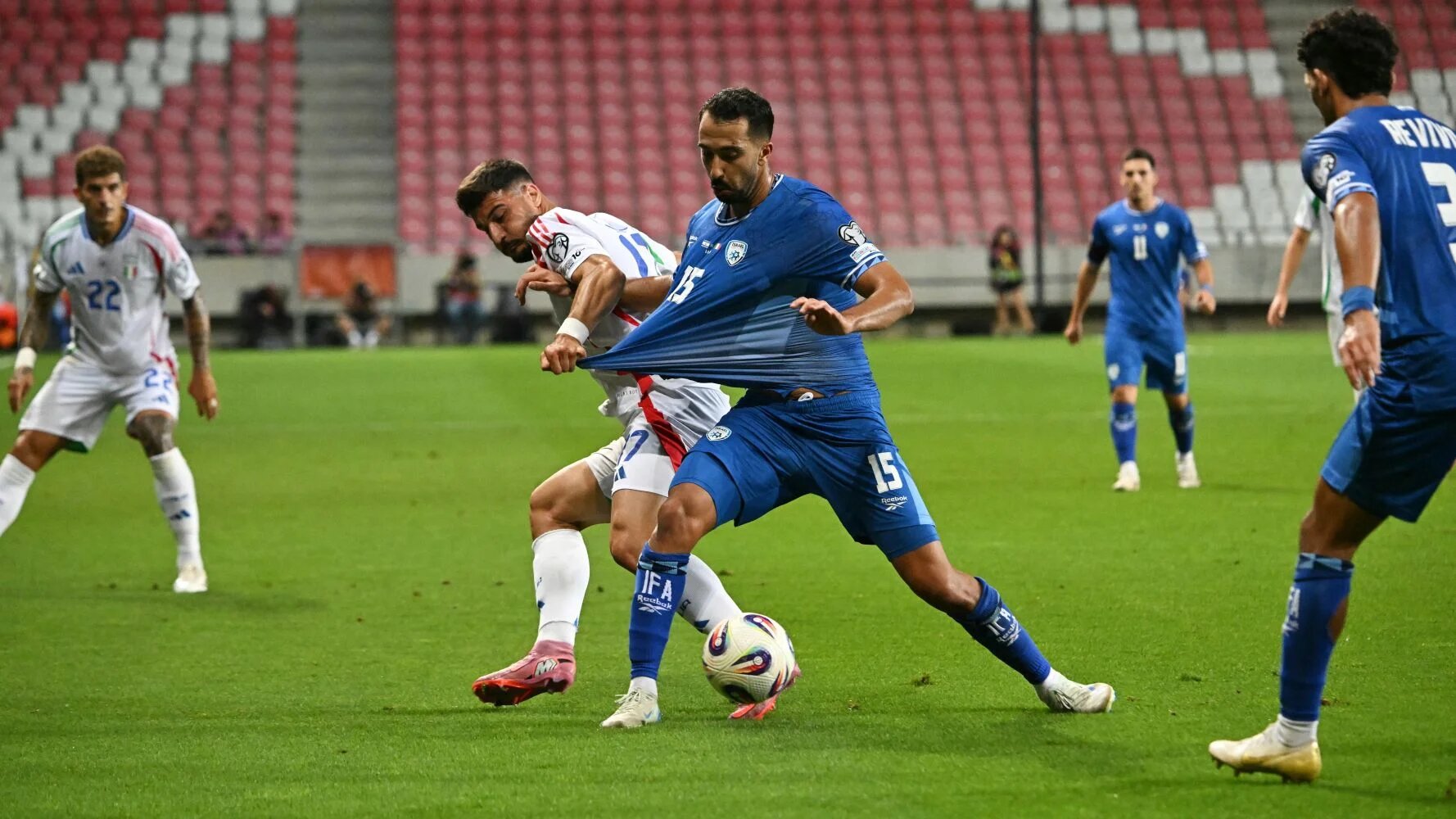 Israel's football team (blue) in action against Italy earlier in September (AFP/Attila Kisbenedek)