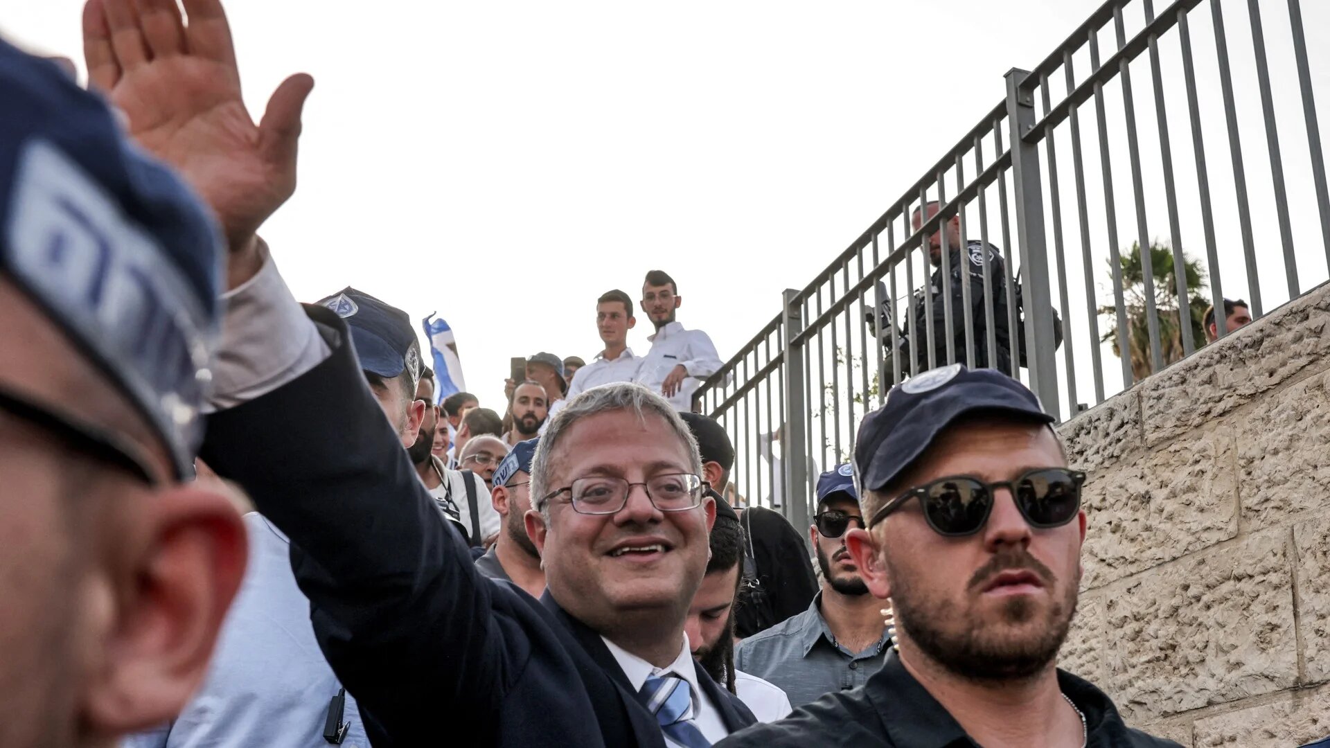 Israeli policemen surround Israeli Minister of National Security and far-right politician Itamar Ben-Gvir as he arrives outside the Damascus Gate of the walled Old City of Jerusalem on 26 May 2025 (Ahmad Gharabli/AFP)