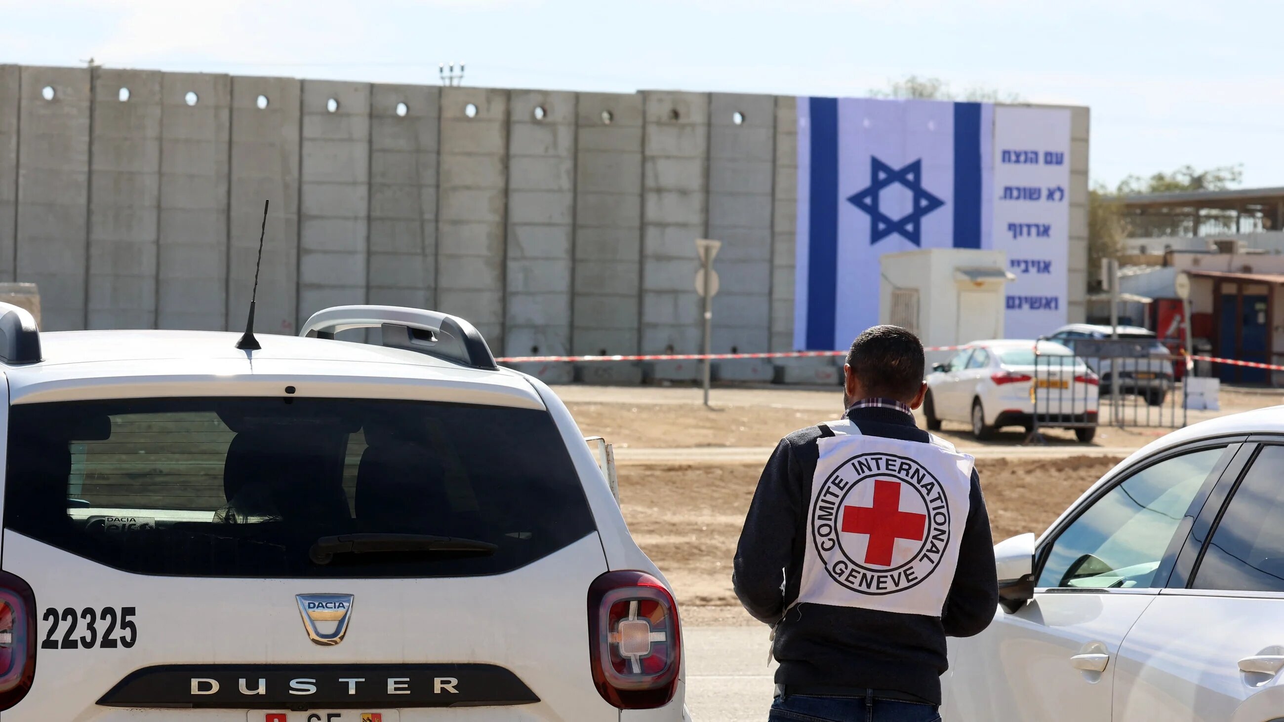 A member of the Red Cross stands outside the Israeli-run Kziot prison in the Negev desert on 25 January, 2025 (AFP/Gil Cohen-Magen)