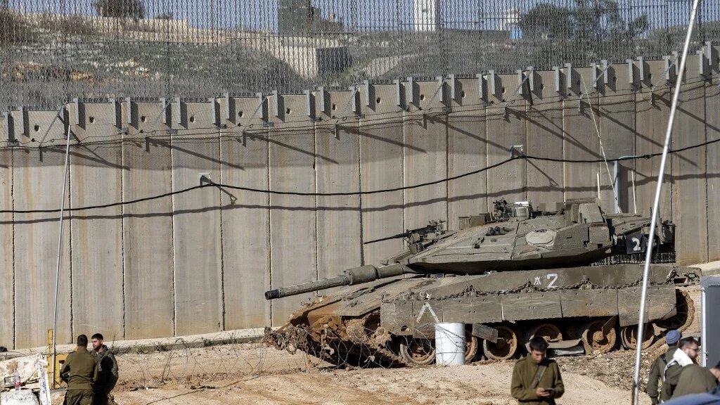 An Israeli tank sits by the Lebanese border on 18 February 2025 (Jalaa Marey/AFP)