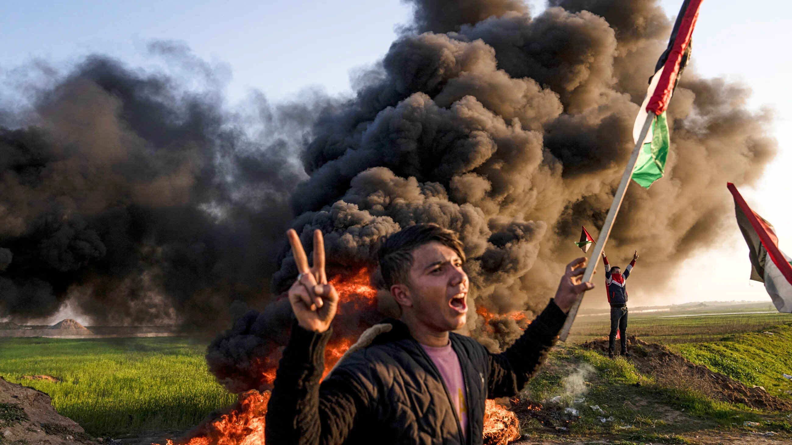 Palestinians east of Gaza City protest against Israeli military raid in the West Bank city of Jenin along the fence with Israel on 16 January 2023 (AP)