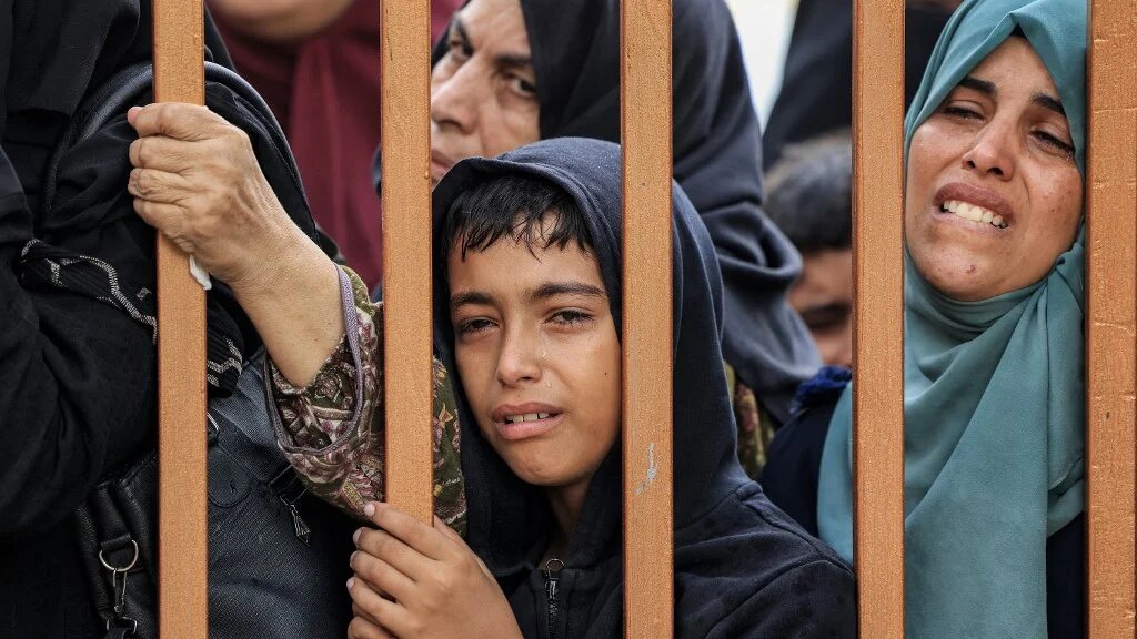People mourn victims of an Israeli bombardment outside a morgue in Khan Younis, in the southern Gaza Strip, on 14 November 2023 (Mahmud Hams/AFP)