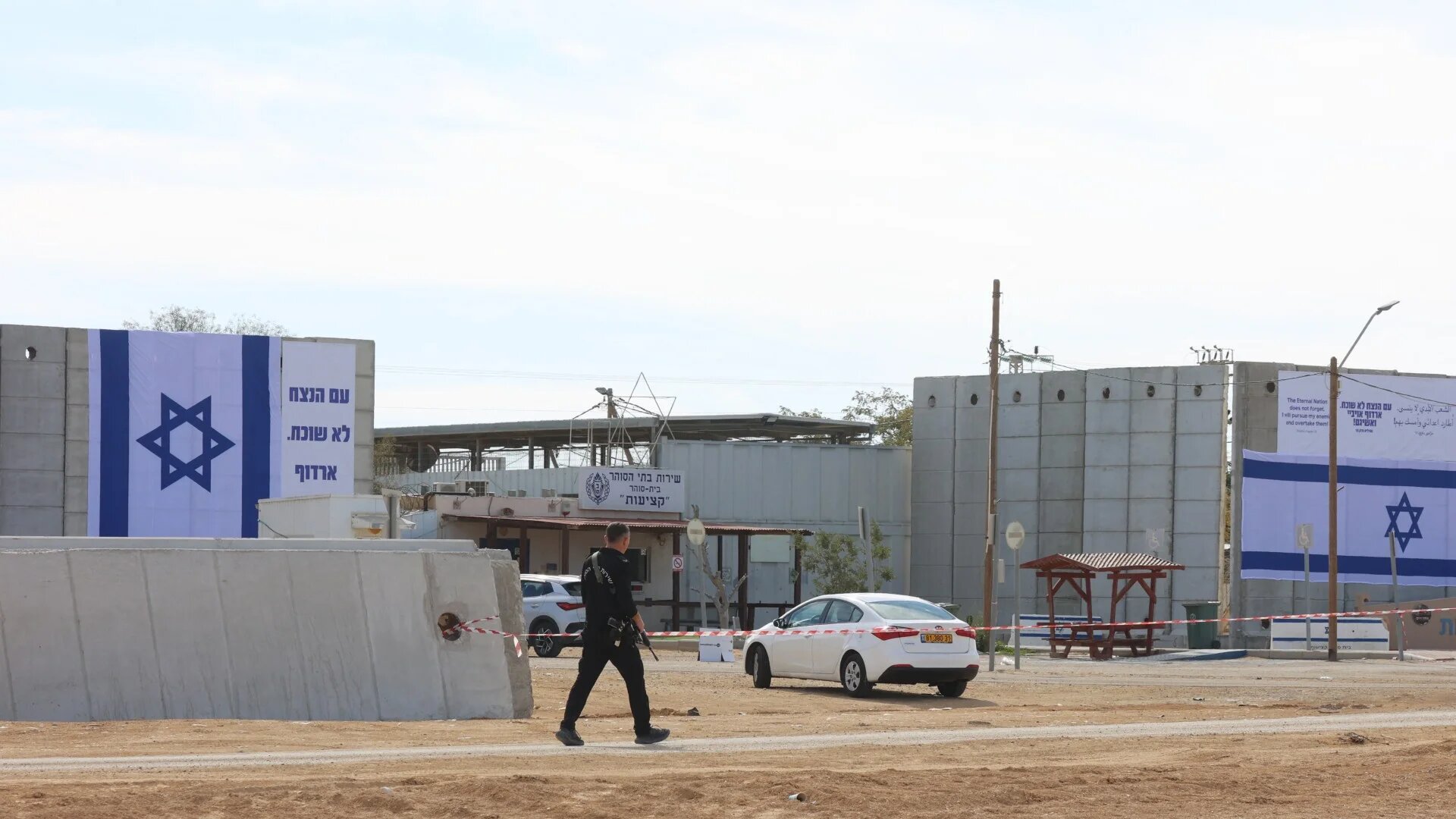 A member of the Israeli security forces walks outside the Kziot prison in the Negev desert on 25 January 2025 (AFP/Gil Cohen Magen)