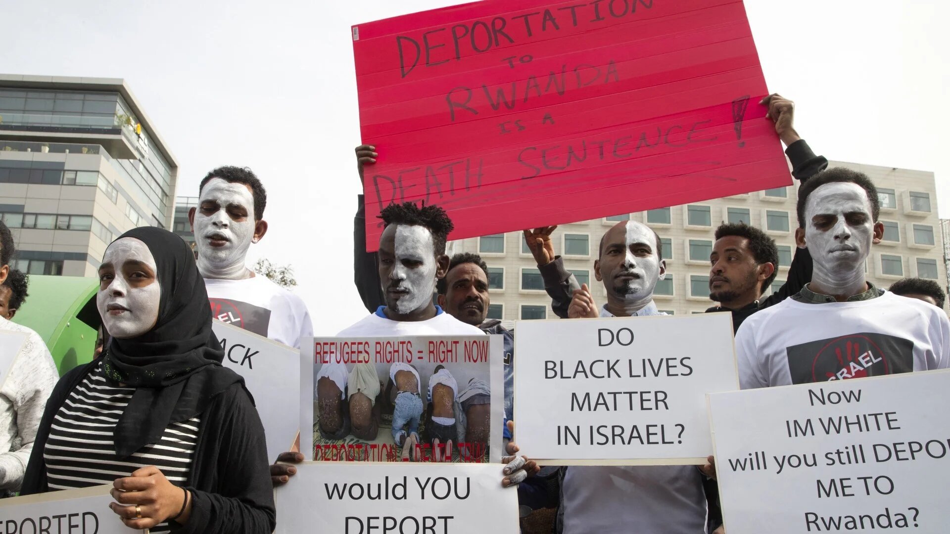 Protesters in the Israeli city of Herzliya on 7 February 2018, marching against the Israeli government's policy to forcibly deport asylum seekers to Rwanda and Uganda (AFP)
