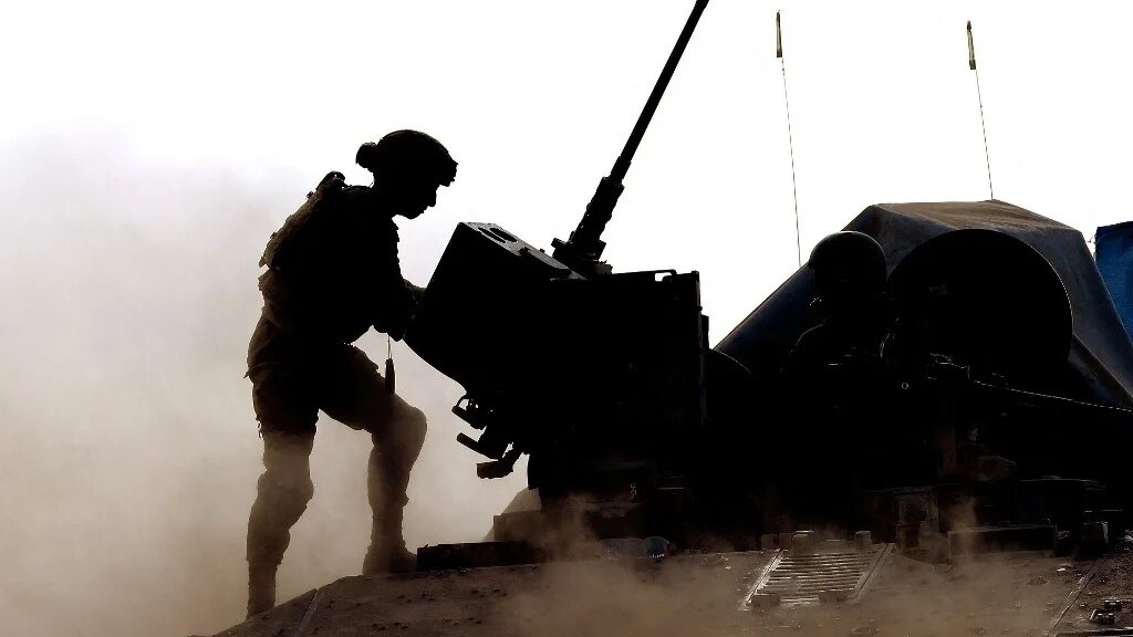 An Israeli soldier stands atop a military vehicle in southern Israel near the border with the Gaza Strip on 29 May 2024 (Jack Guez/AFP)