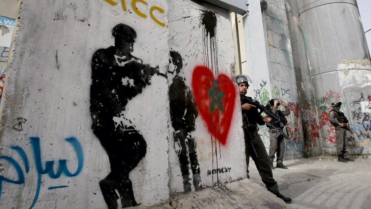 An Israeli border guard holds position by Israel's controversial separation barrier on 26 April 2017 in the West Bank city of Bethlehem.