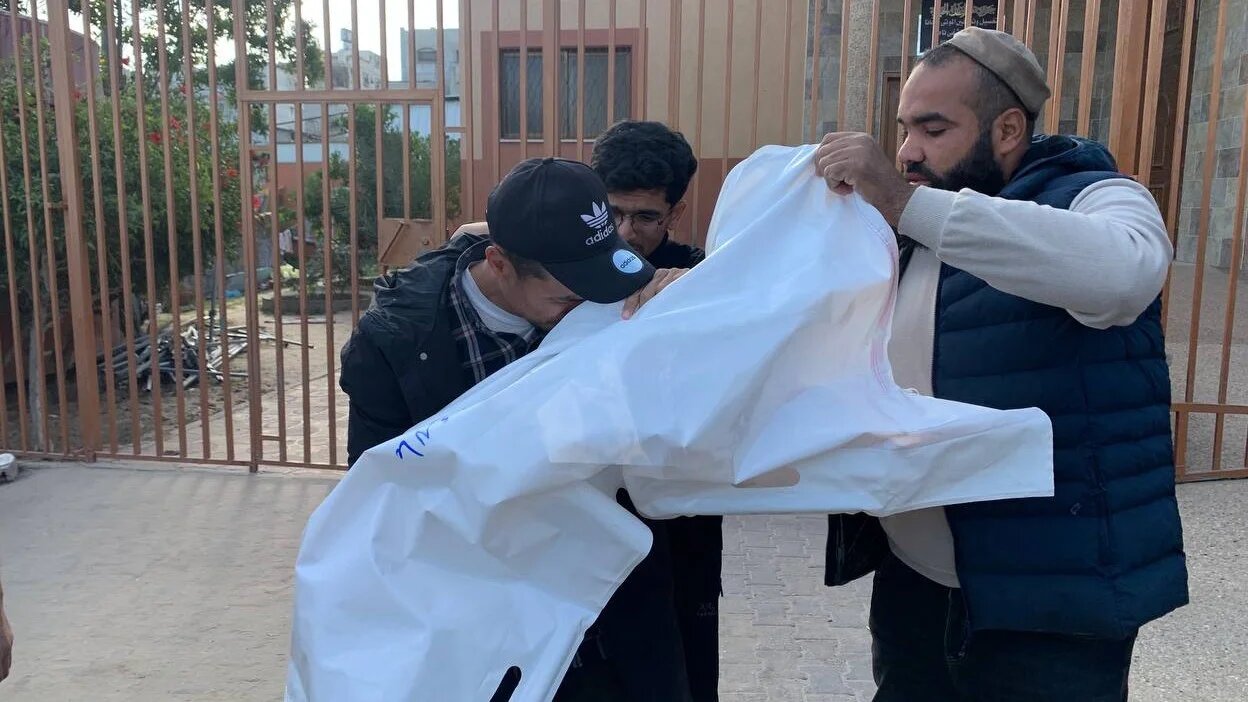 Palestinians mourn a child on 15 April 2025, killed during overnight Israeli strikes on Khan Younis (MEE/Ahmed Aziz)