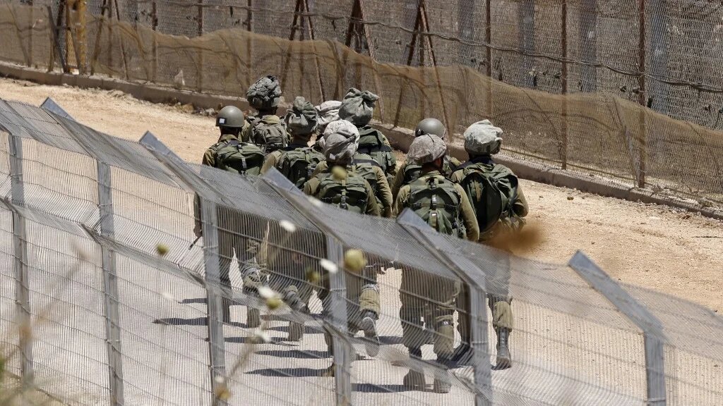 Israeli troops patrol the border fence with Syria near the Druze village of Majdal Shams in the occupied Golan Heights on 23 July 2025 (Jalaa Marey/AFP)