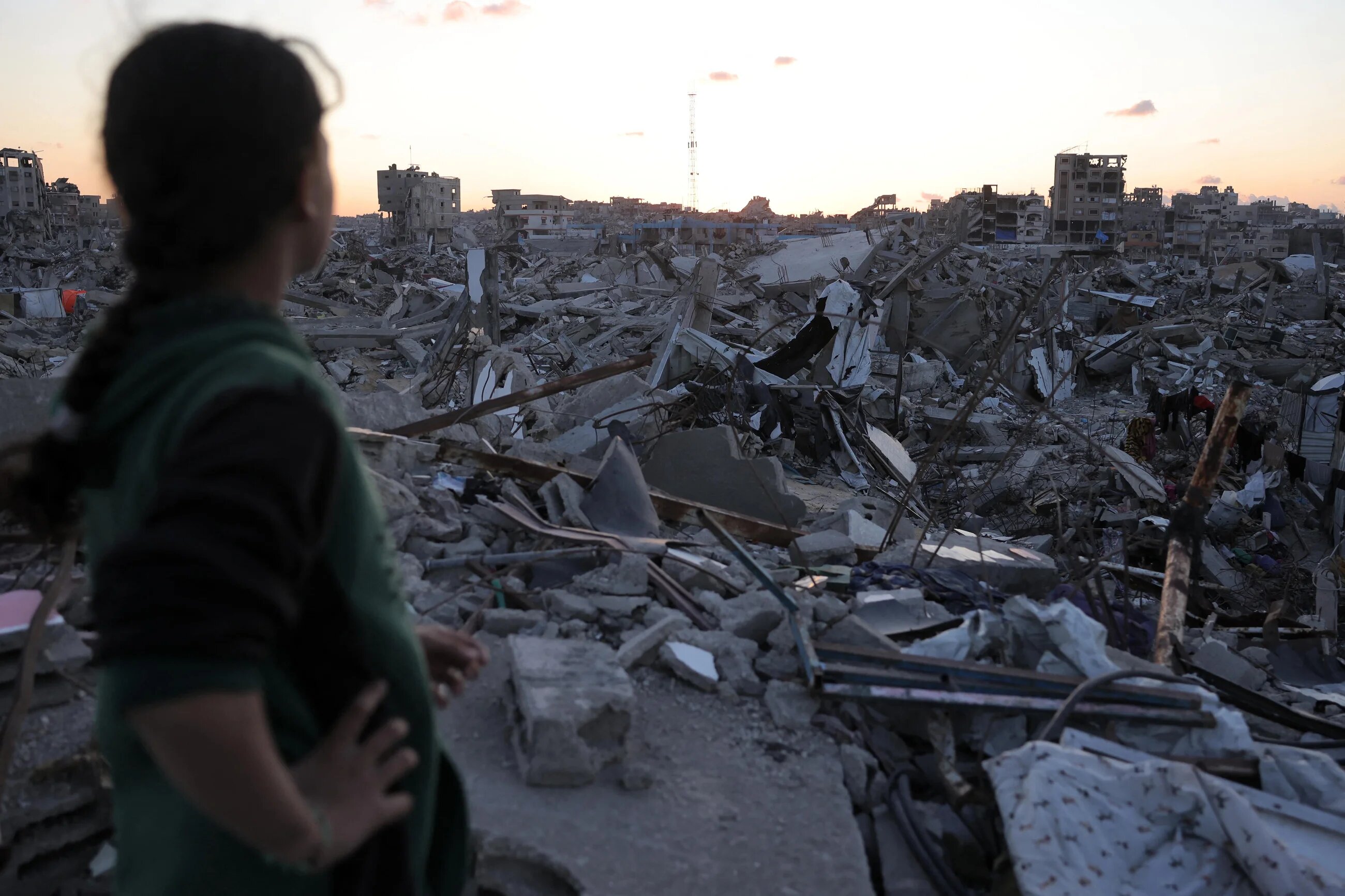 A girl stands rubble in Jabalia, north Gaza, caused by Israel's over 18 month-long bombardment of the besieged enclave (AFP/Bashar Taleb)