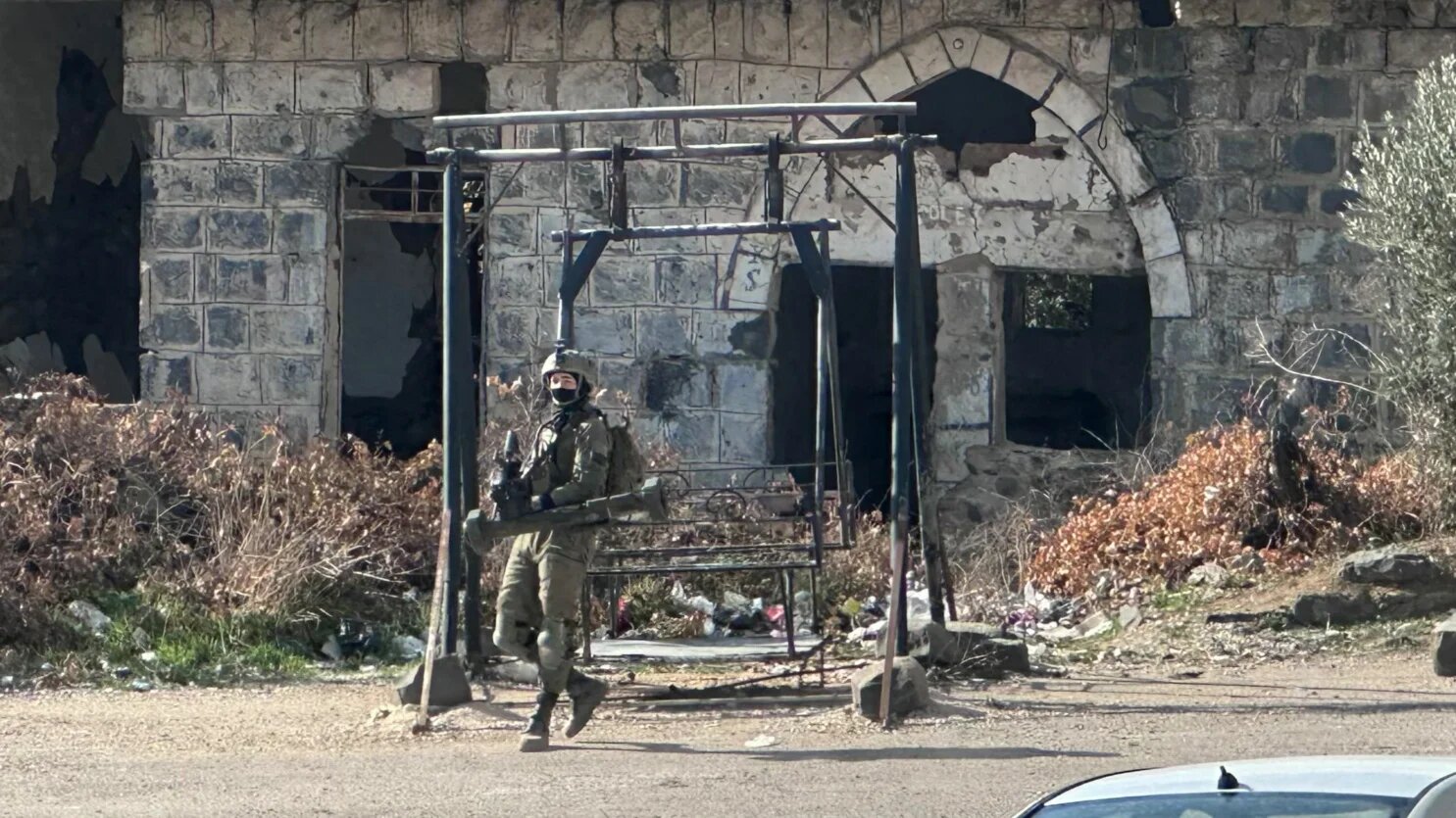 An Israeli soldier takes a position in the Syrian town of Jubata al-Khashab, in the UN-patrolled buffer zone in the occupied Golan Heights on 20 December 2024 (Bakr Alkasem/AFP)