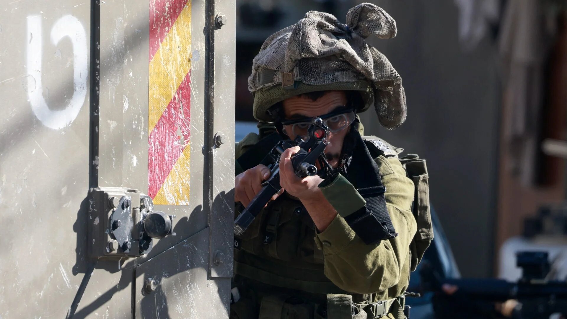 An Israeli soldier takes aim outside the Tubas Turkish Governmental Hospital in Tubas in the occupied West Bank on December 3, 2024.