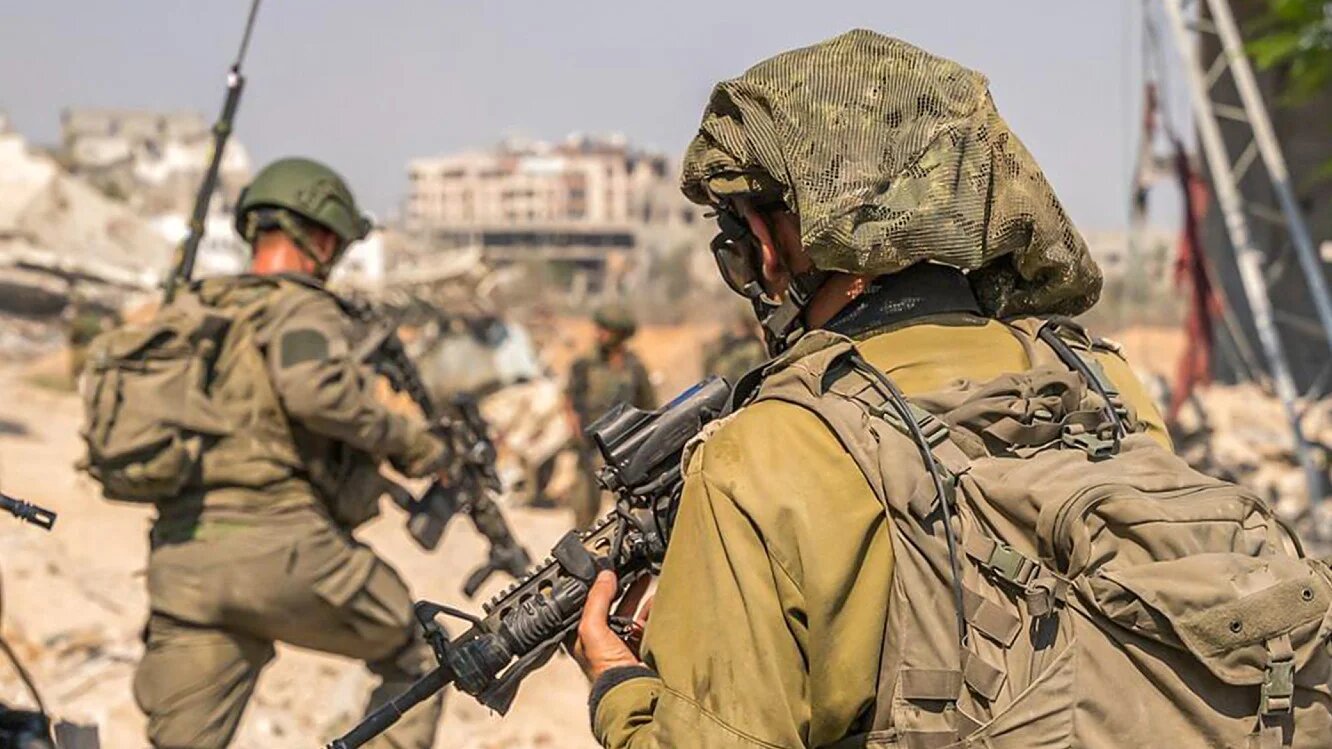 In this handout picture released by the Israeli army on 30 August 2024 heavily armed Israeli soldiers can be seen walking in the Gaza Strip (Israeli army/AFP)